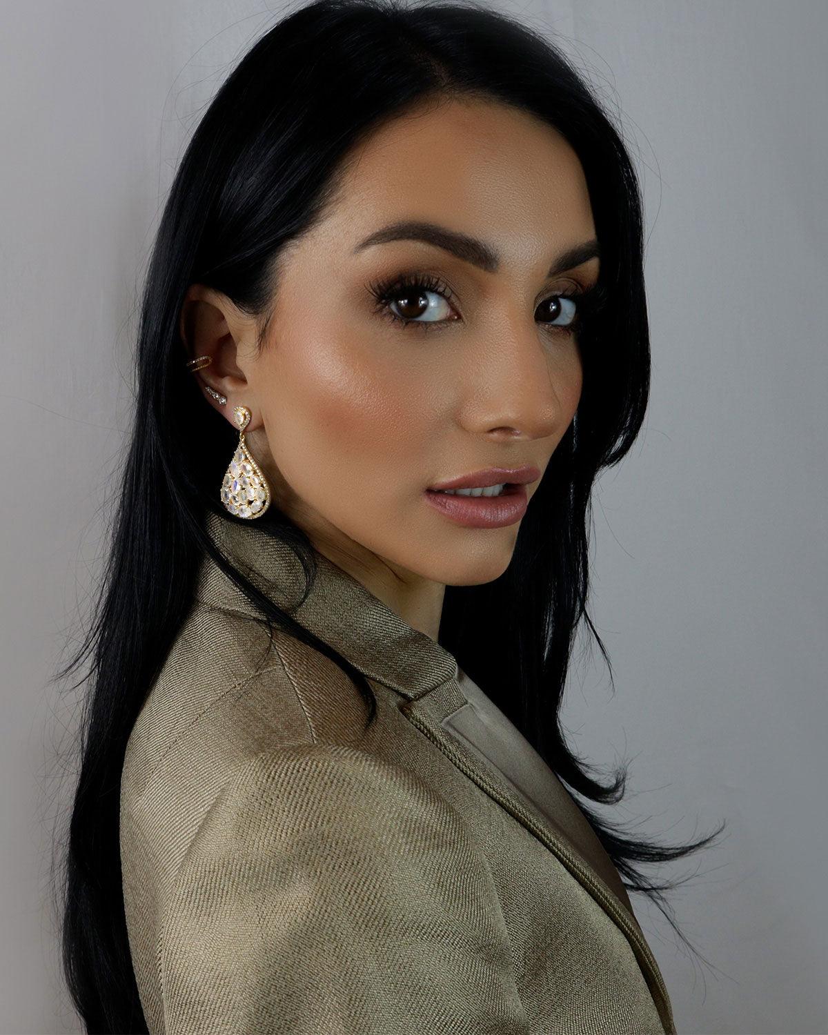 Side angle of silver statement earrings with faceted labradorite