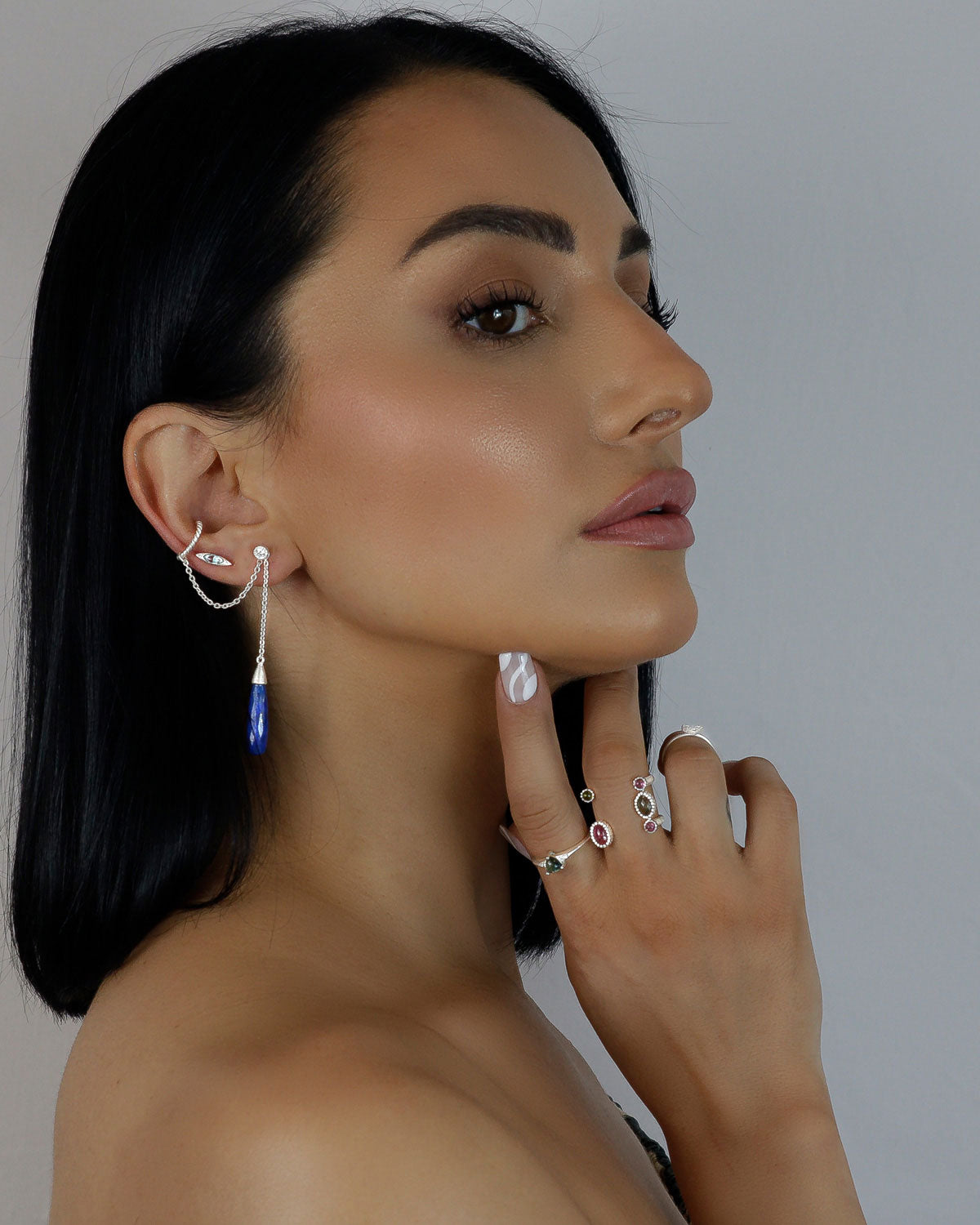 Model wearing sterling silver earrings with lapis lazuli gemstones