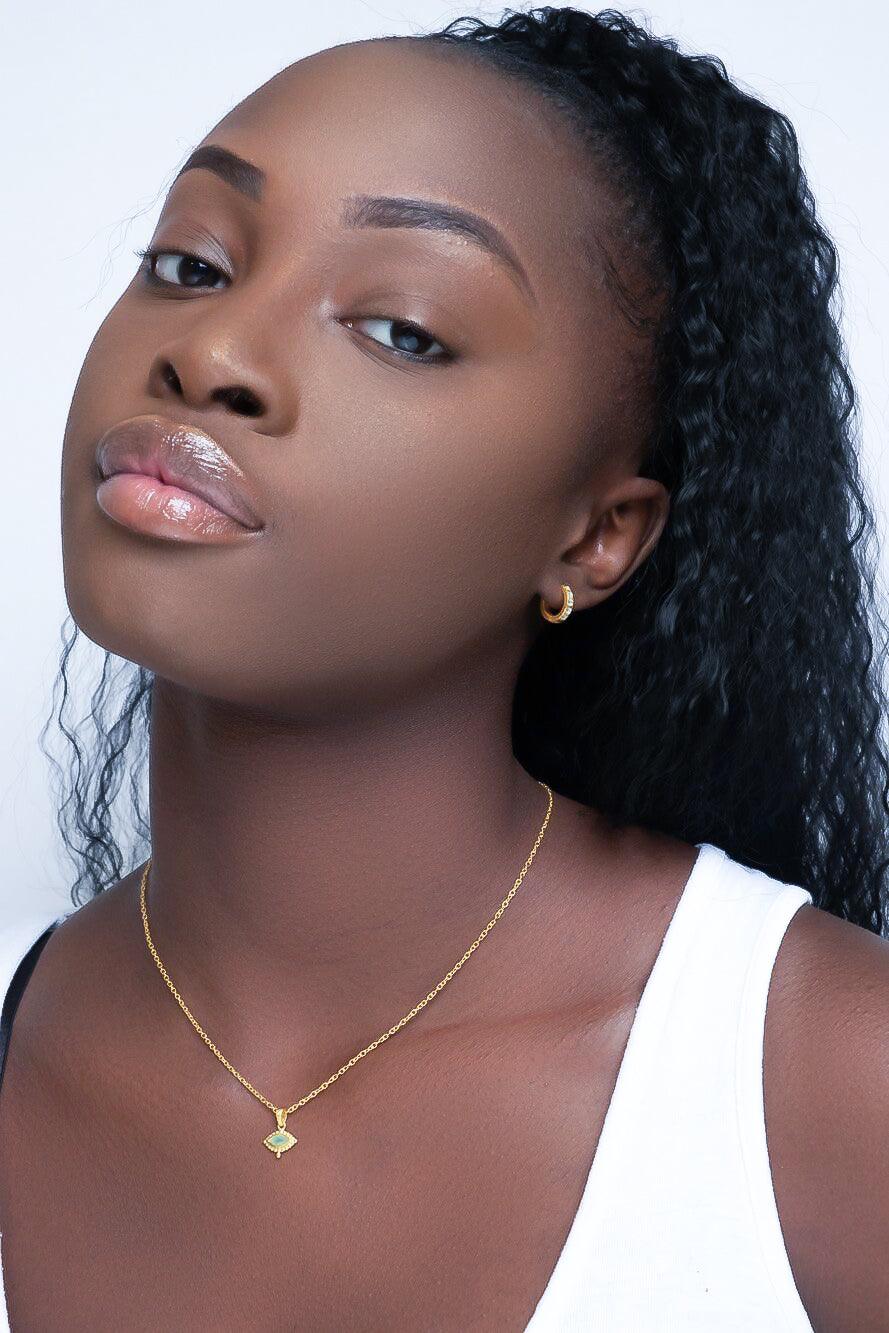 Model wearing silver eye necklace with natural amethyst gemstone