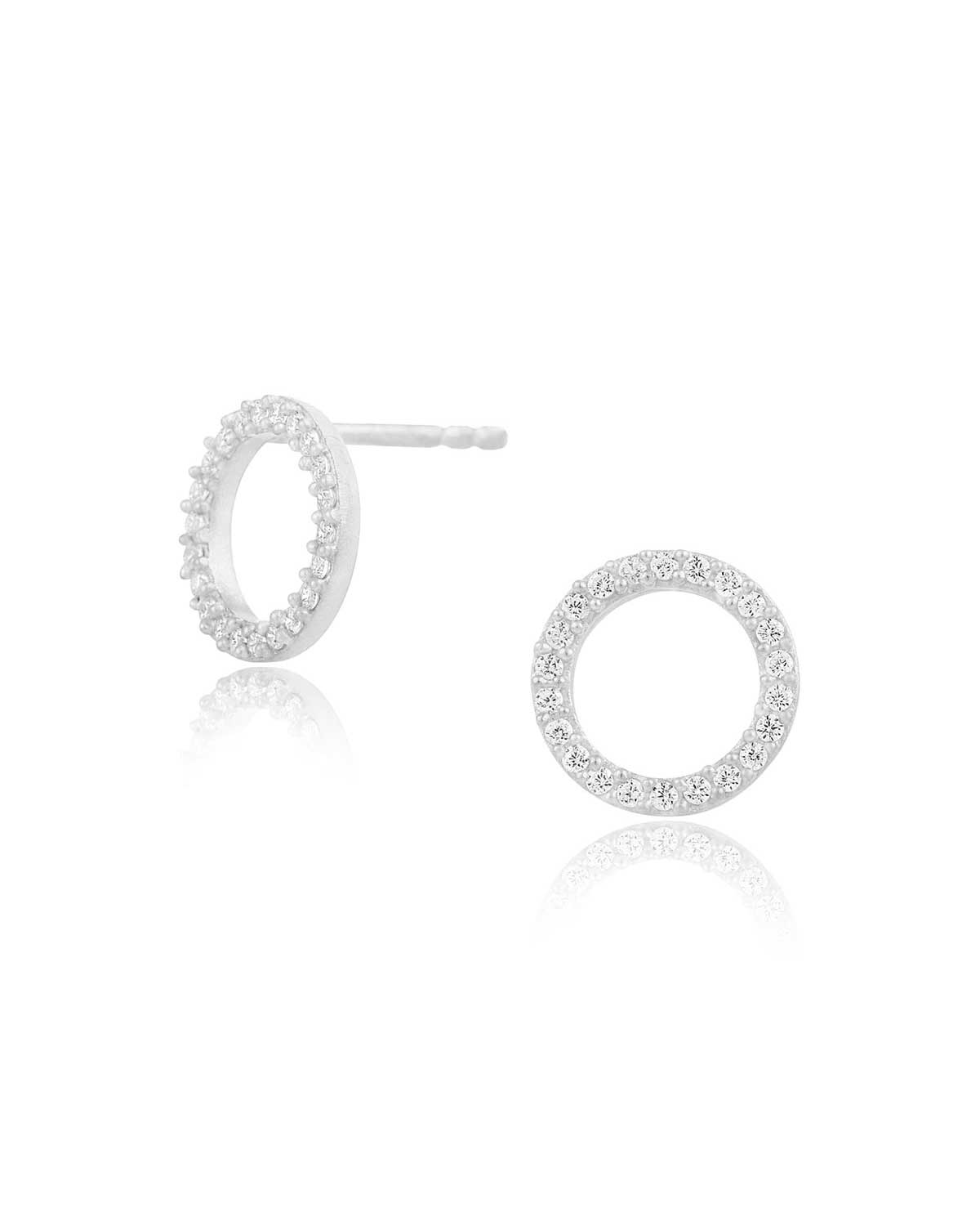 Circular silver stud earrings with a matte finish and crystal detailing