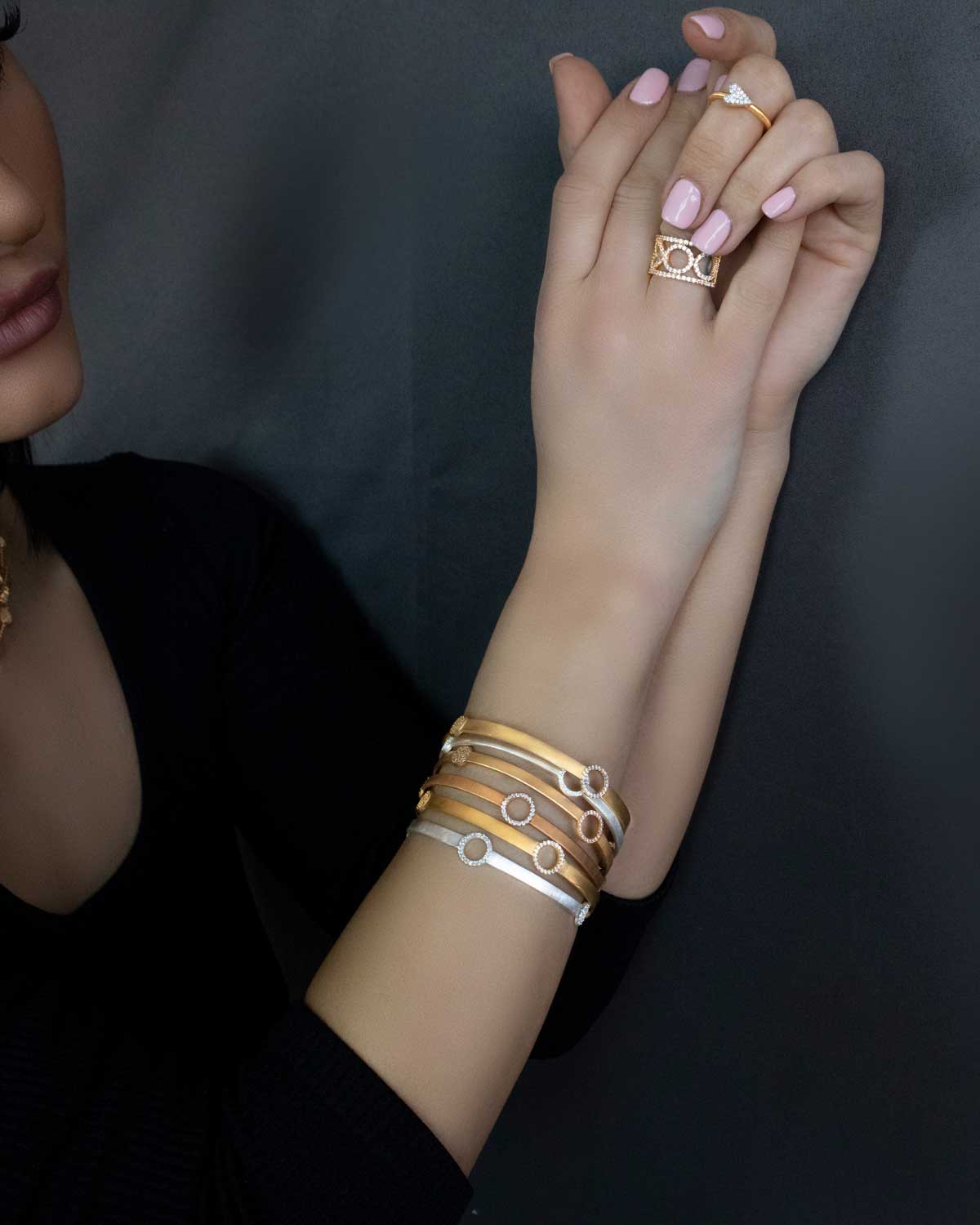 Model wearing gold bangle with AAA grade crystals
