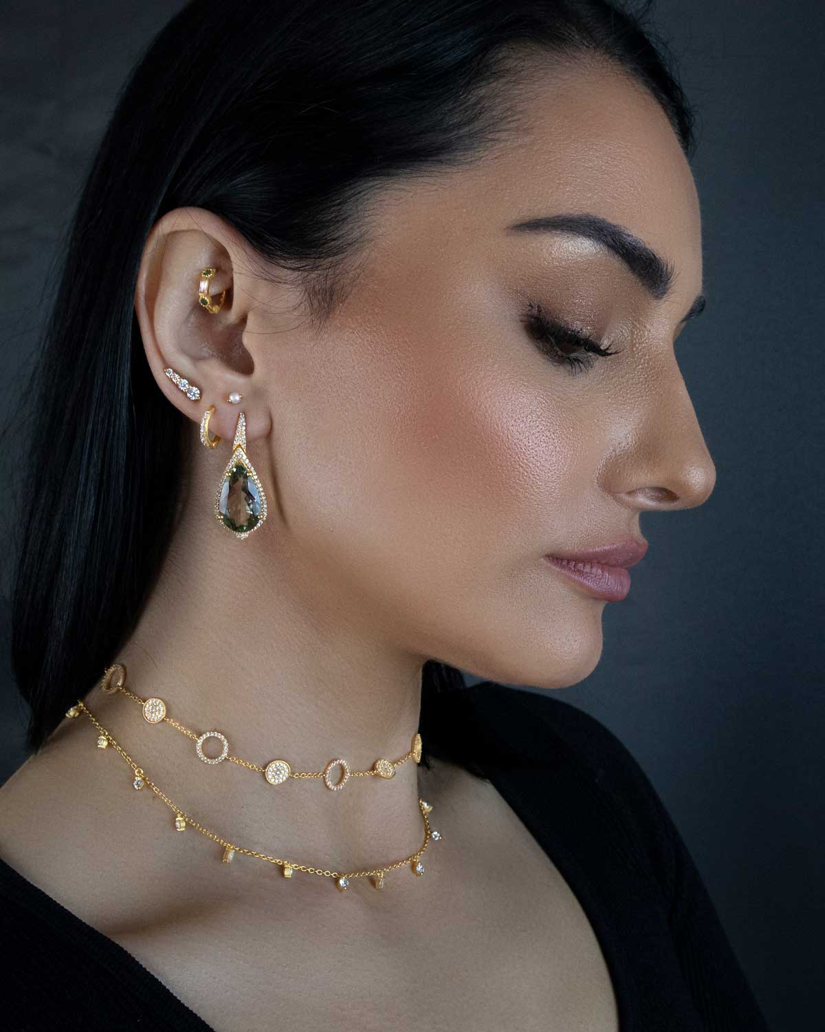 Model wearing silver necklace with subtle crystal sparkle
