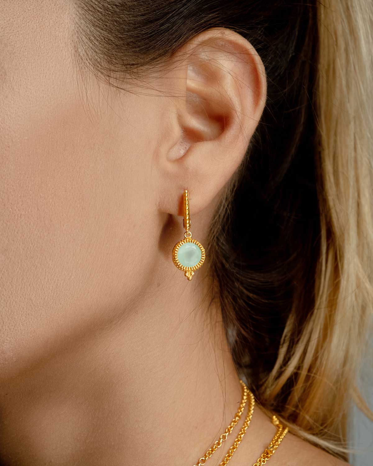 Model wearing silver mini hoop earrings with smoky quartz drops