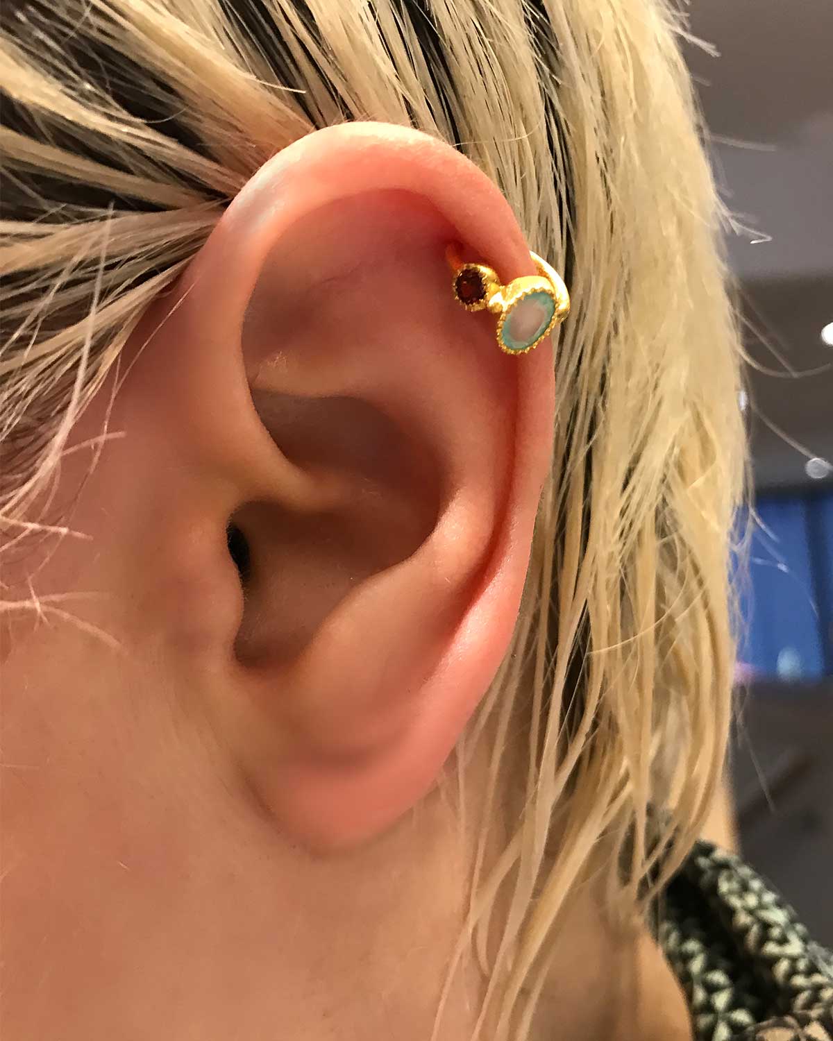 Side angle of silver mini hoops with garnet and aqua calcedony stones