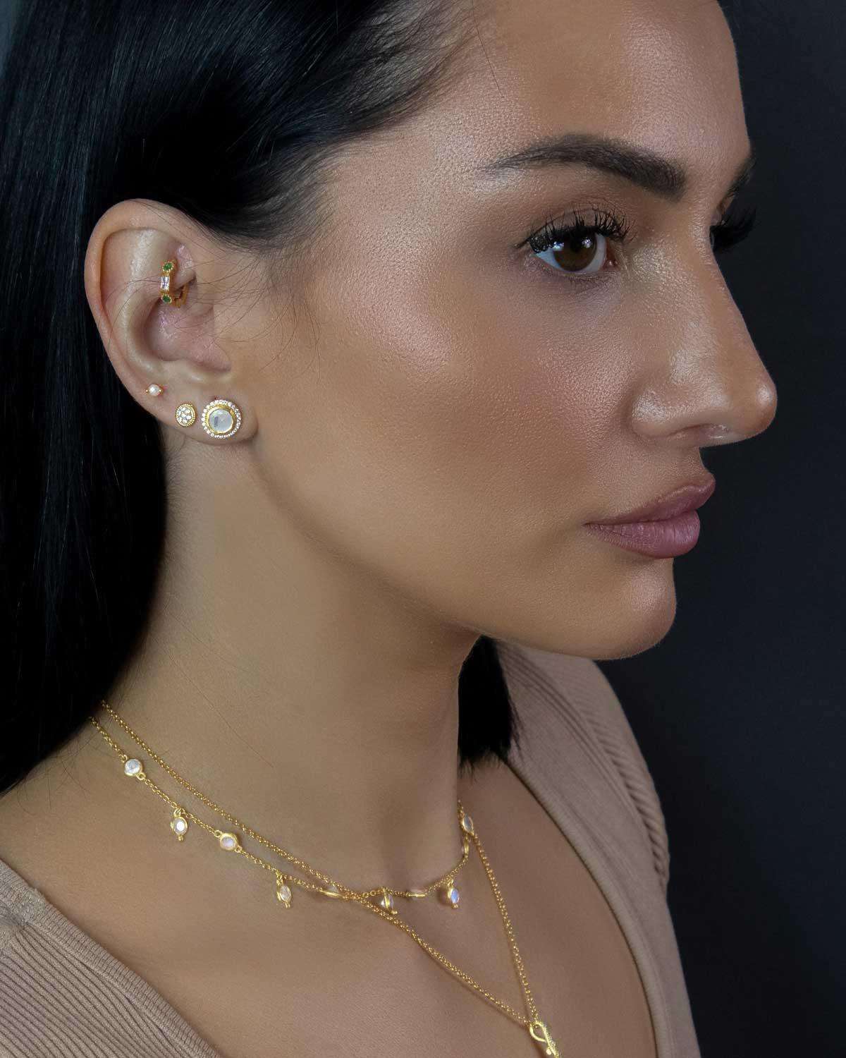 Close-up of rainbow moonstone gemstones in a gold and rose gold necklace