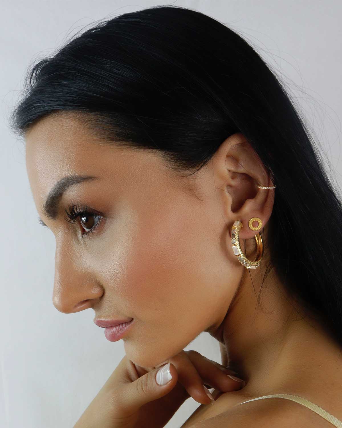 Side angle of gold hoops with moonstone and labradorite gemstones