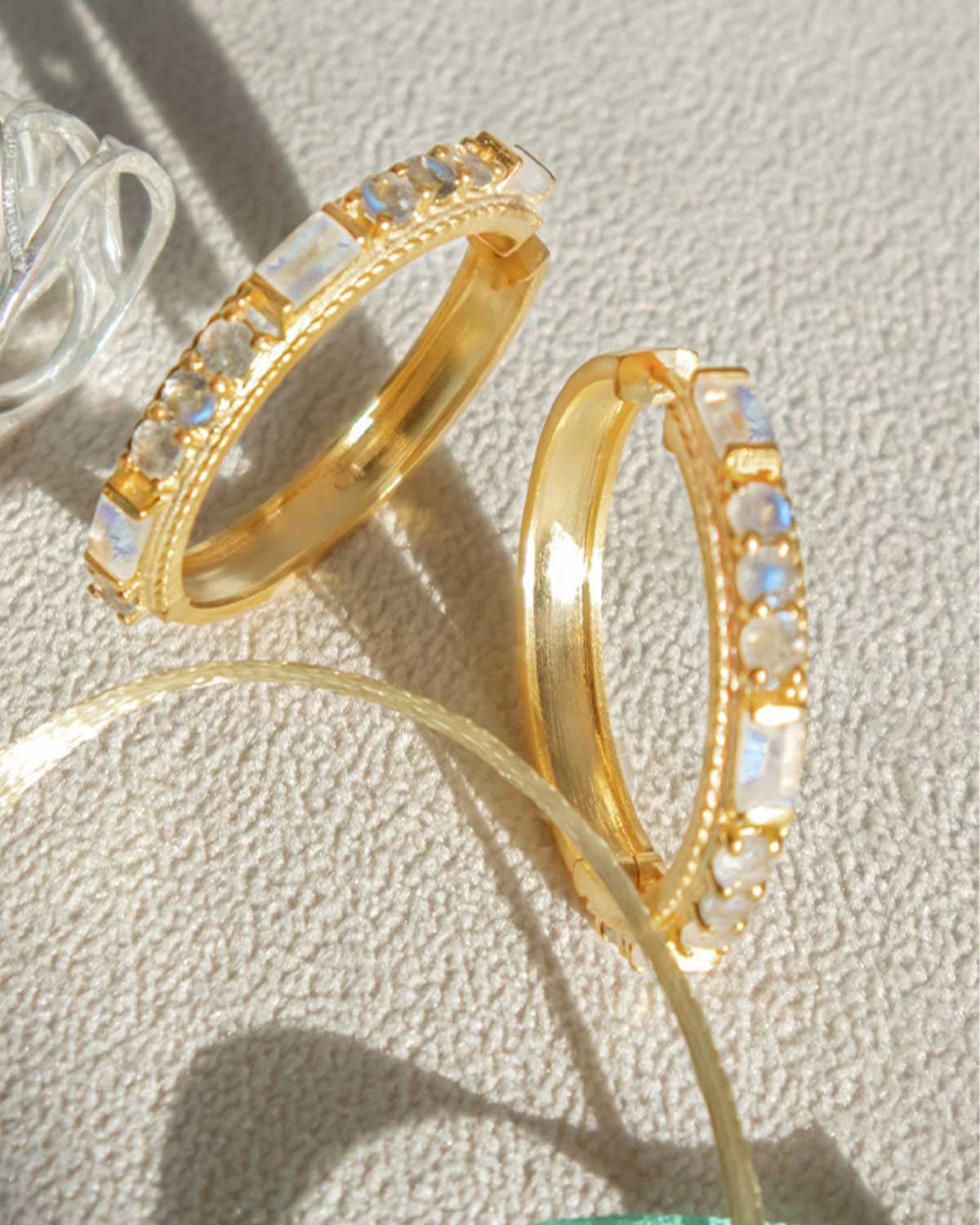 Gold hoops with mixed gemstone texture and polished finish