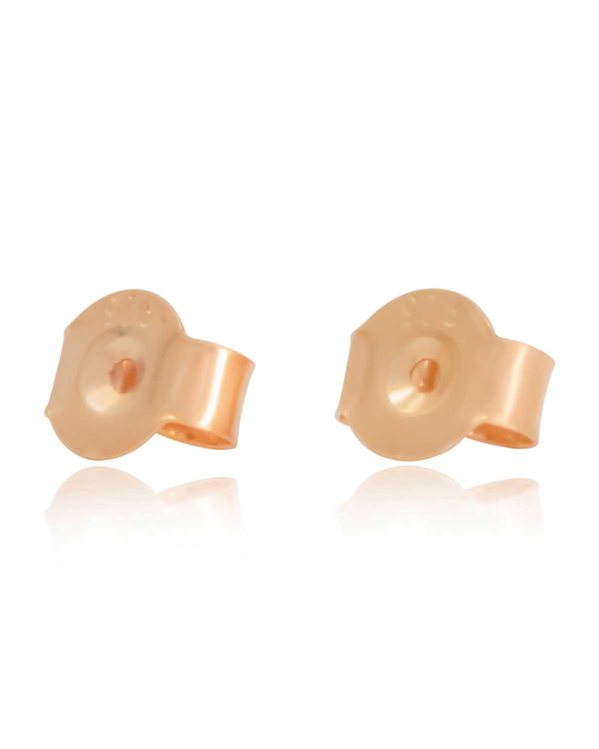 Pink tourmaline stud earrings styled with stacked huggies and studs