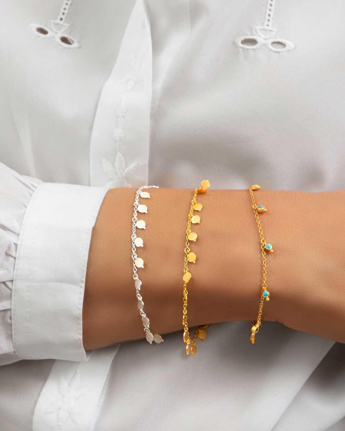 Model wearing silver bracelet with green onyx gemstones