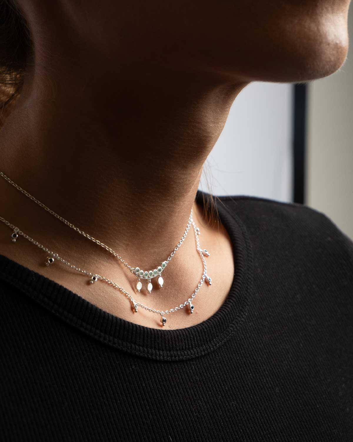 Close-up of silver necklace with hand-cut black spinel gemstones