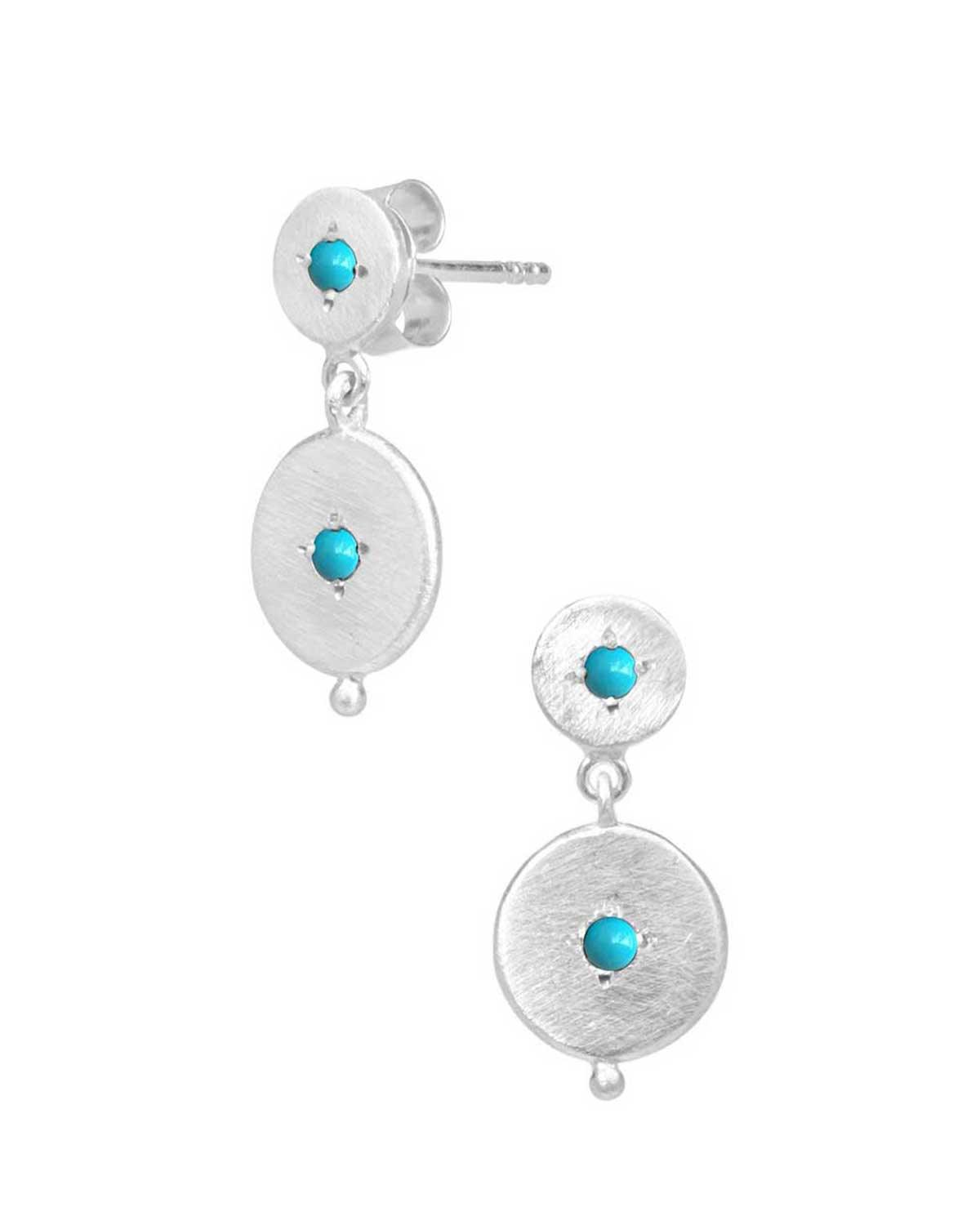 Close-up of silver double disk earrings with hand-cut gemstones