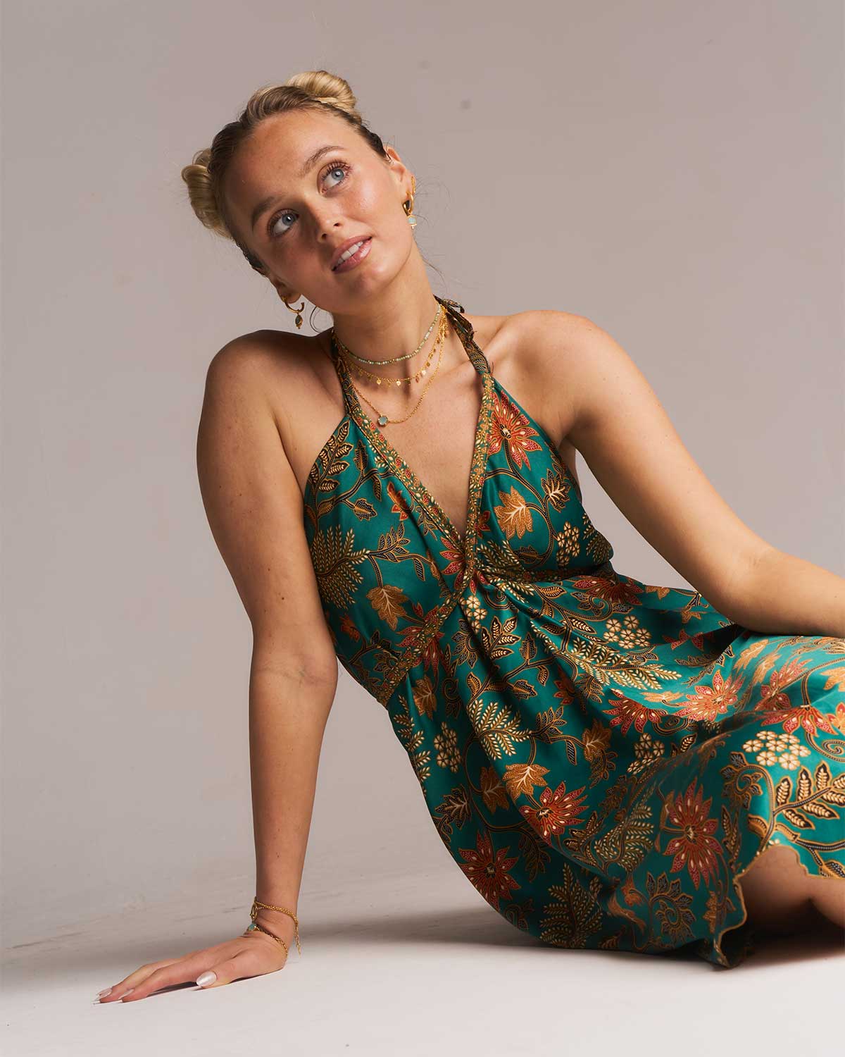 Model wearing a gold adjustable necklace with an aqua chalcedony gemstone