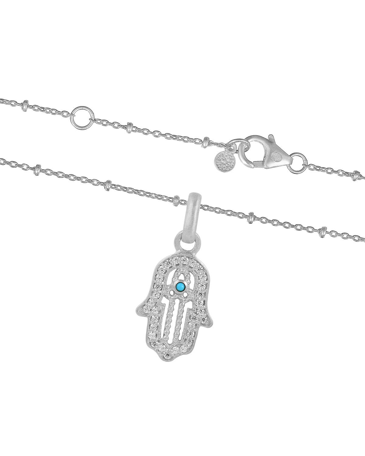Close-up of sterling silver necklace featuring a hand of blessing pendant with lab diamonds and turquoise