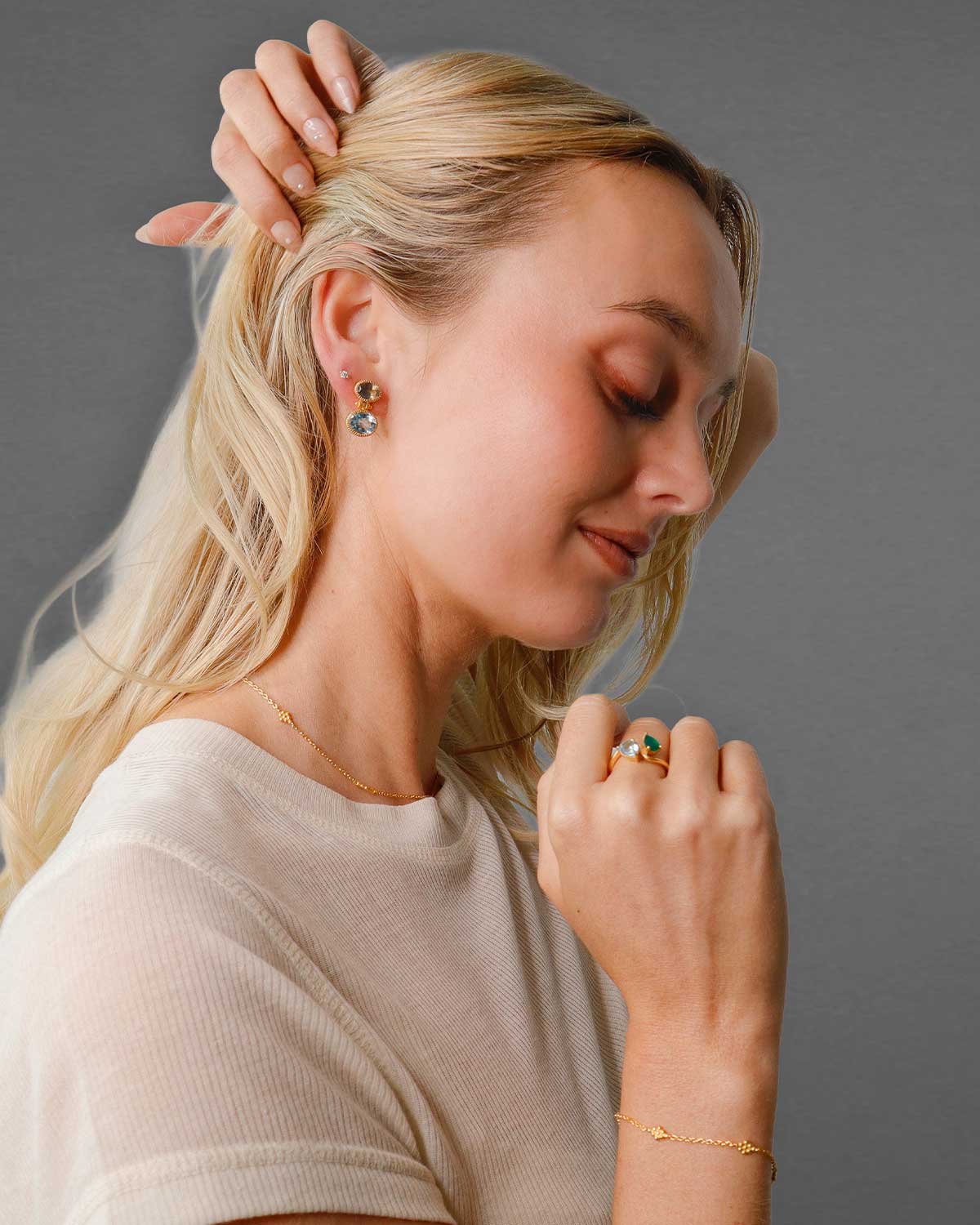 side view of gold vermeil earrings with blue topaz and labradorite, showcasing their elegant design