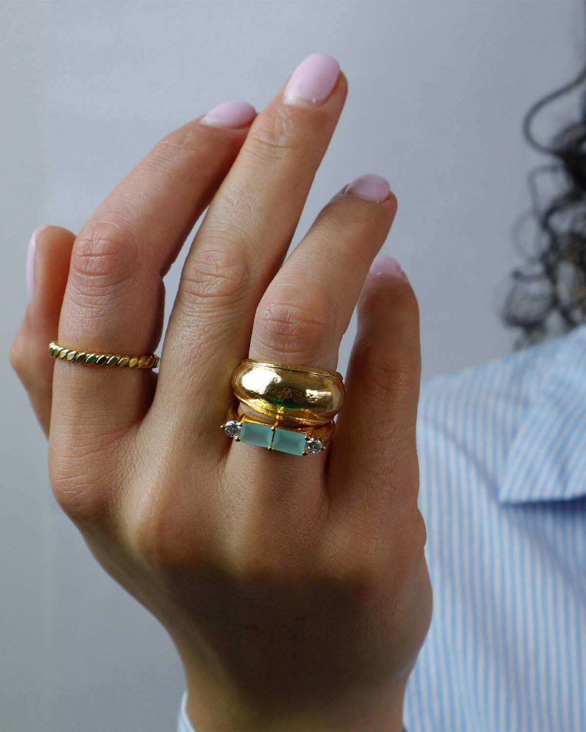 Close-up of a chunky gold ring with an unusual textured surface
