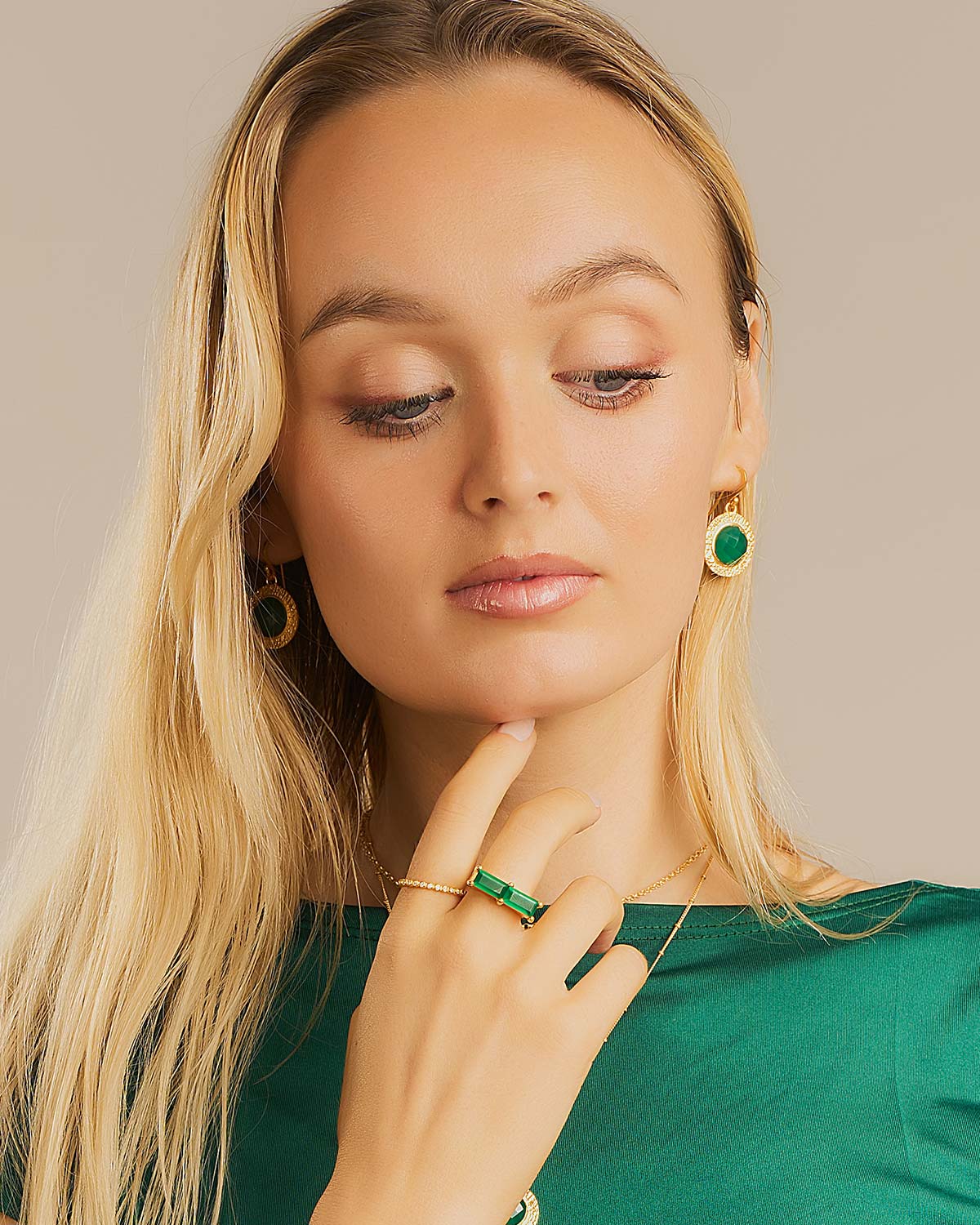 Gold earrings with circular green onyx gemstones said to benefit respiratory and nervous system