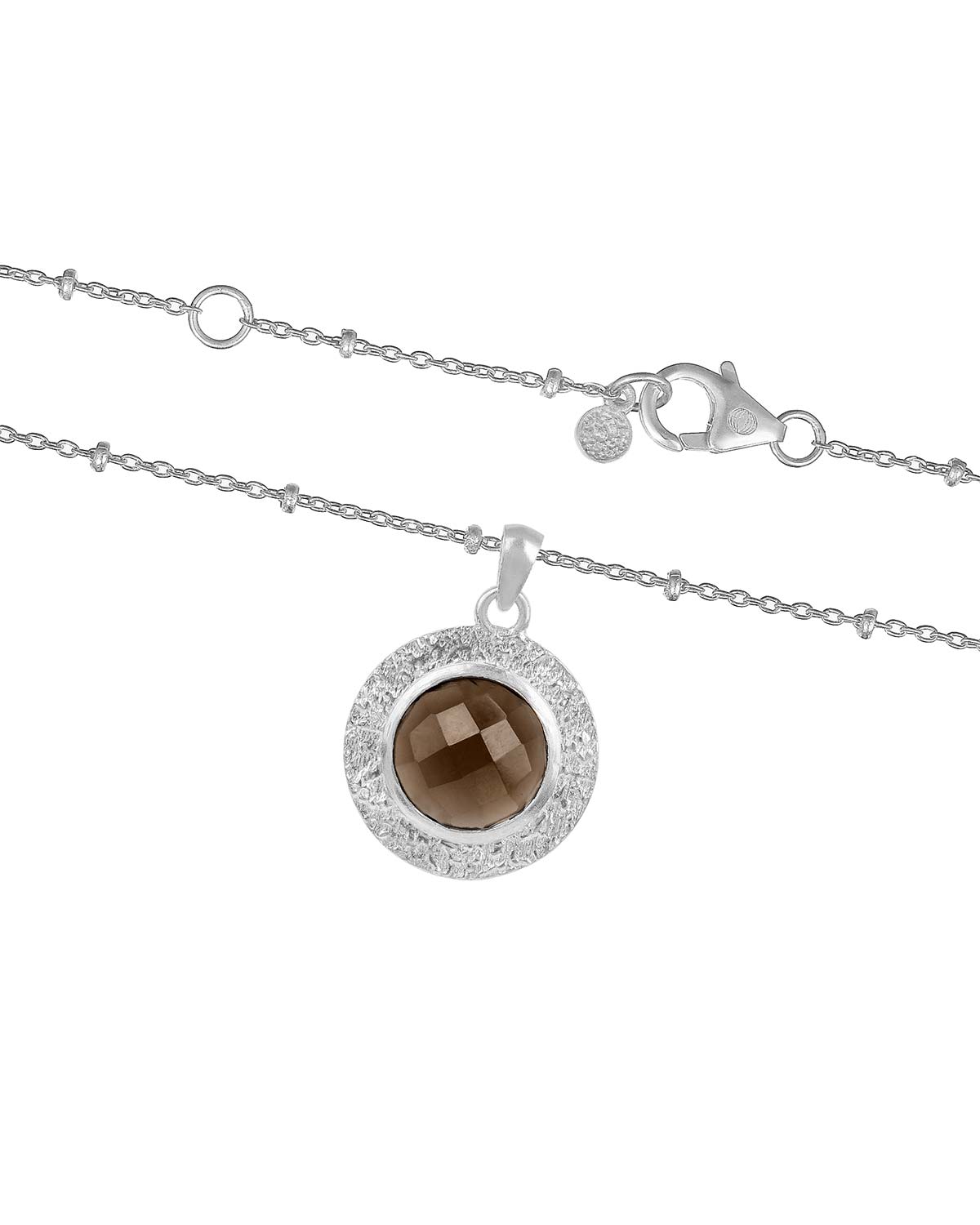 Close-up of a bold gold necklace with a circular smoky quartz gemstone