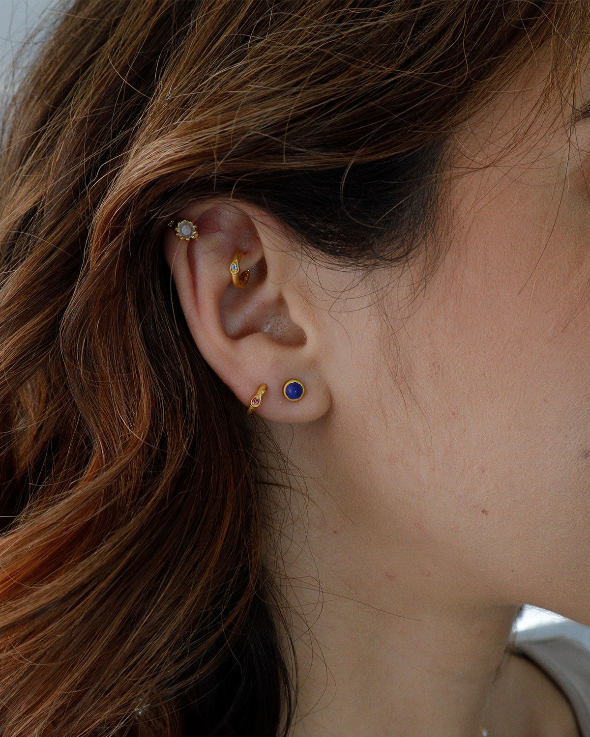 Model wearing lapis lazuli stud earrings in a simple style