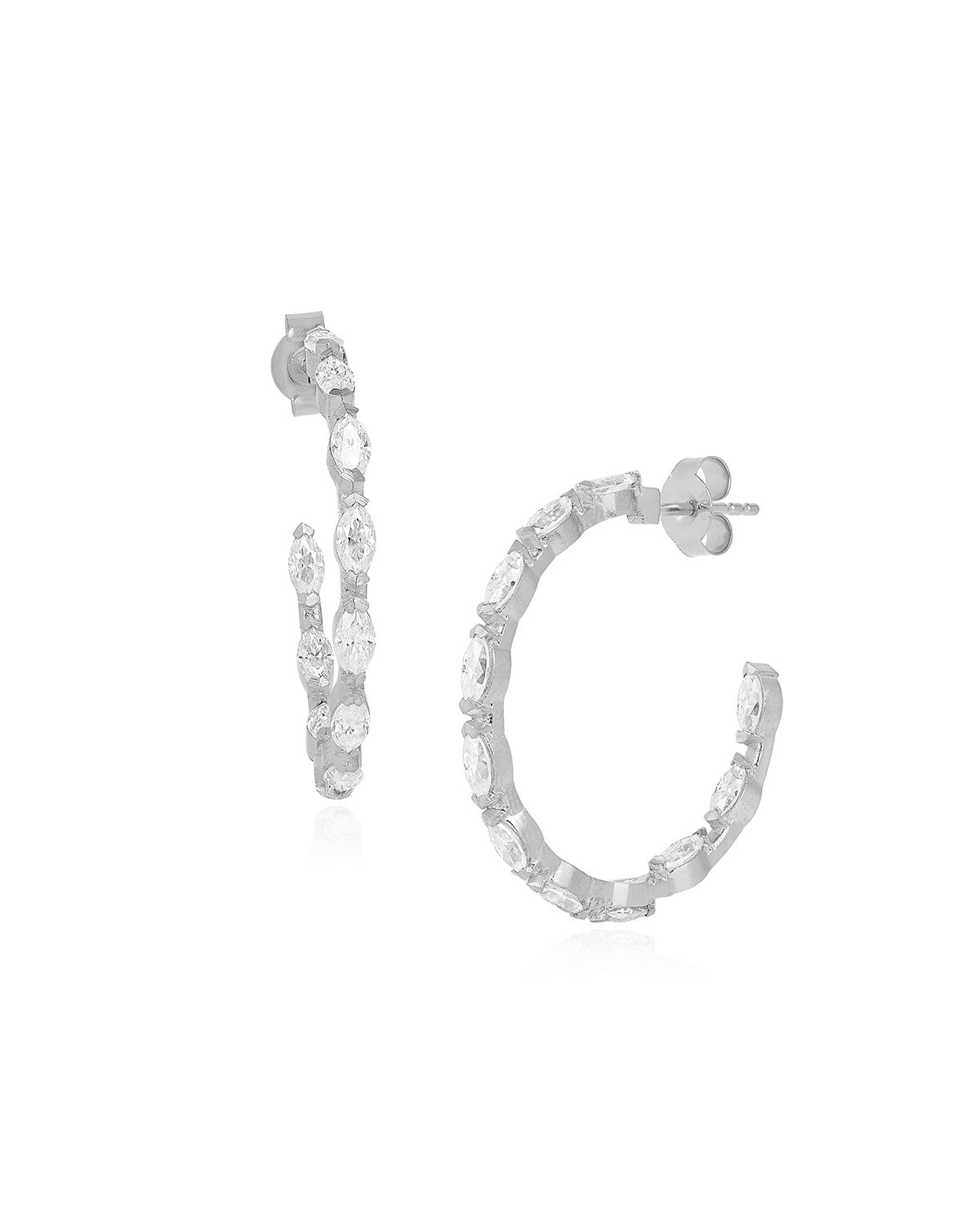 Close-up of silver hoop earrings with hand-set marquise-cut zirconia gemstones