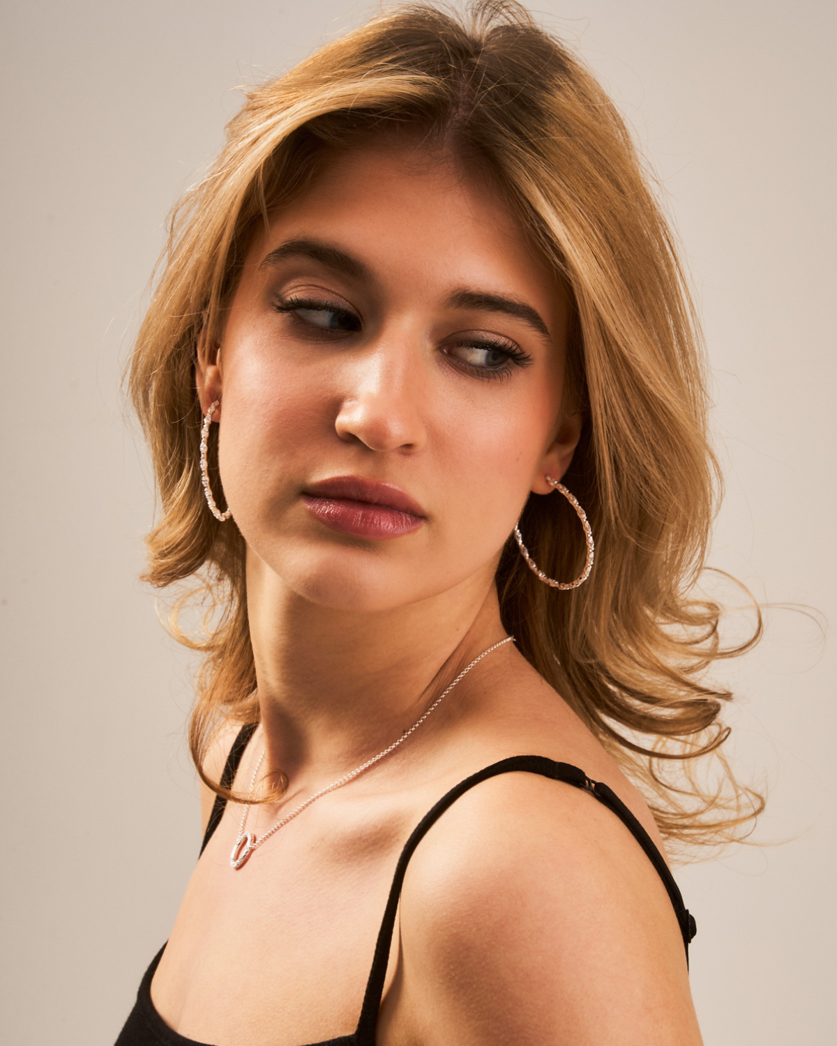 Small-size silver hoop earrings with sparkling zirconia gemstones