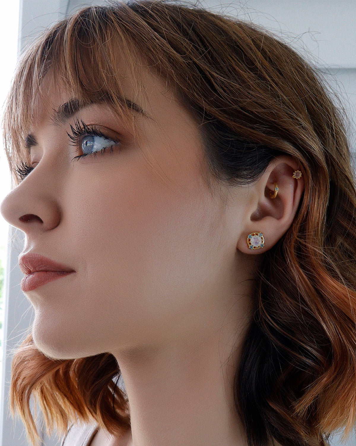 Detailed view of moonstone and blue topaz gemstones in gold studs