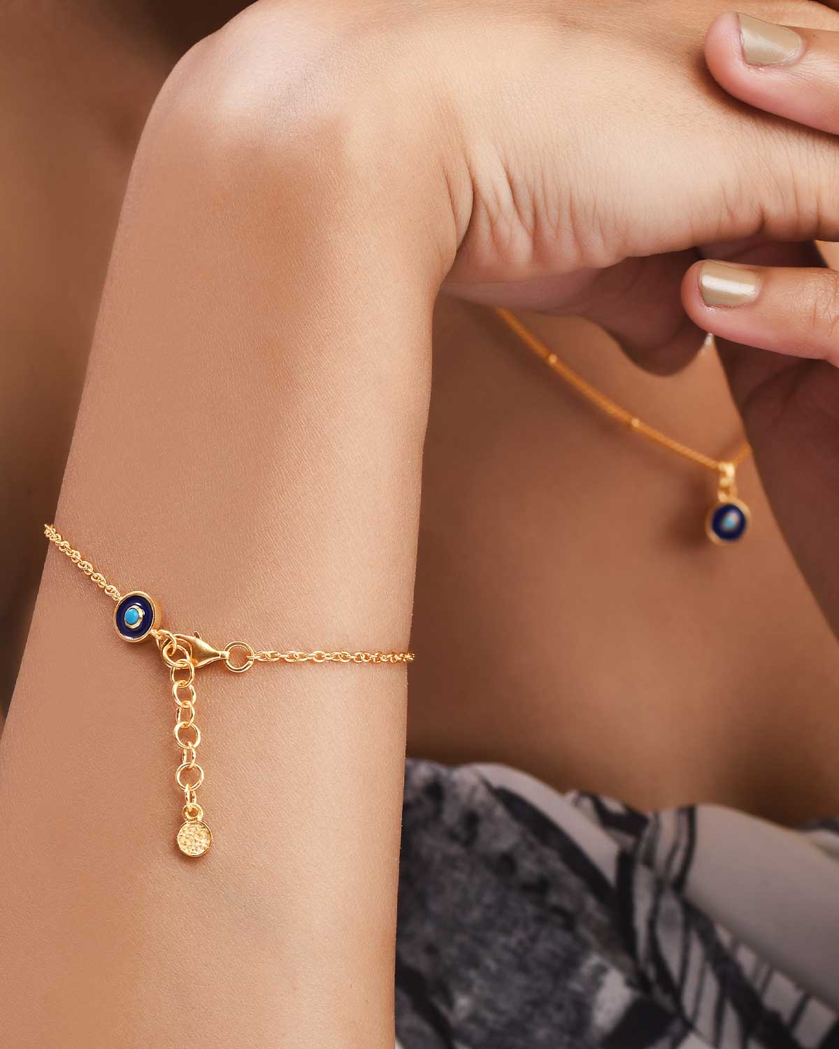 Model wearing gold vermeil evil eye bracelet with turquoise gemstone
