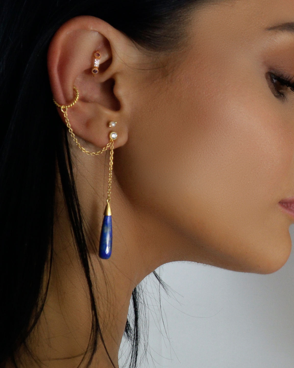 Gold vermeil lapis lazuli earrings worn as a single stud