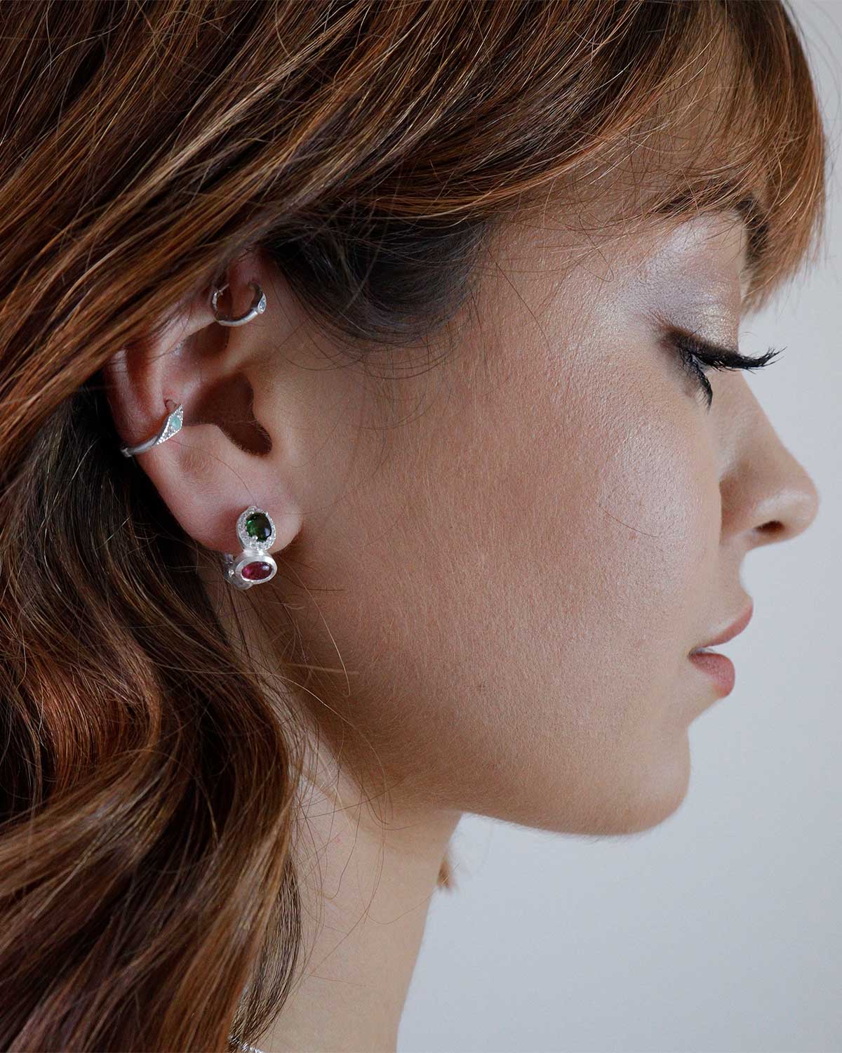 Model wearing silver mini hoops with mixed tourmaline gemstones