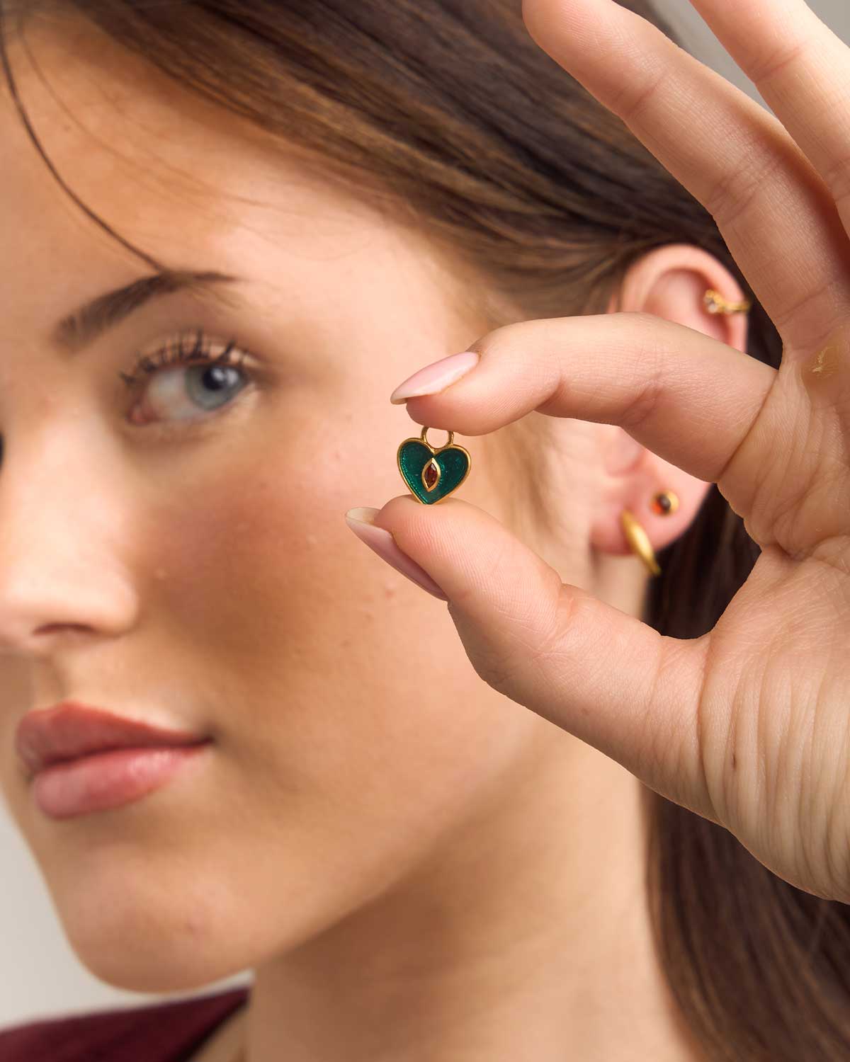 Close-up detail of garnet gold vermeil mini hoops