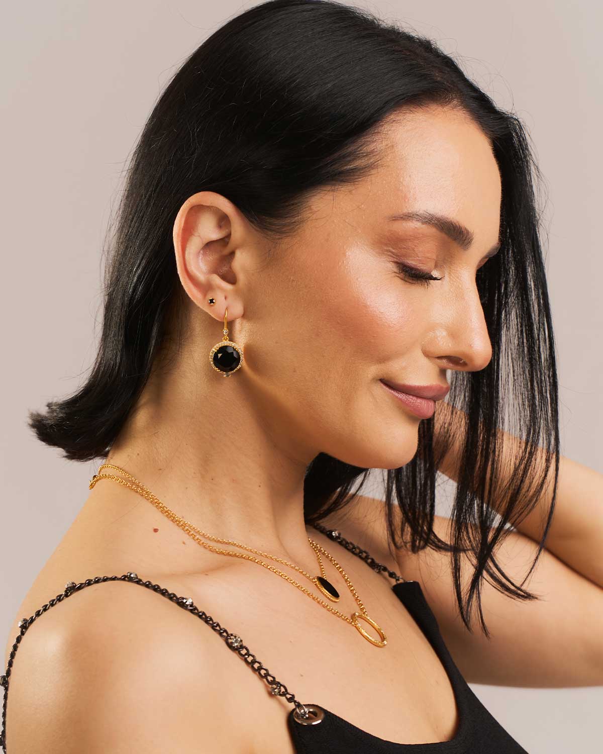 Model wearing sterling silver earrings with black spinel and labradorite gemstones