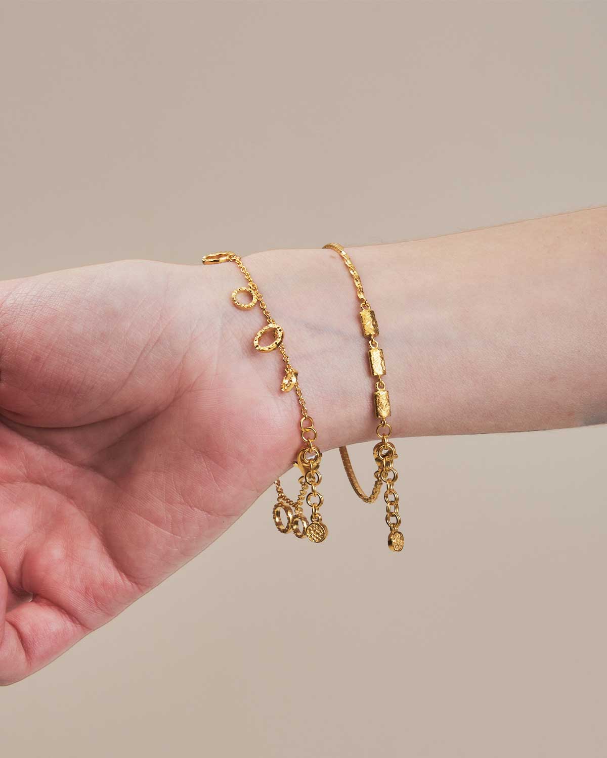 Gold hammered adjustable bracelets worn on a wrist