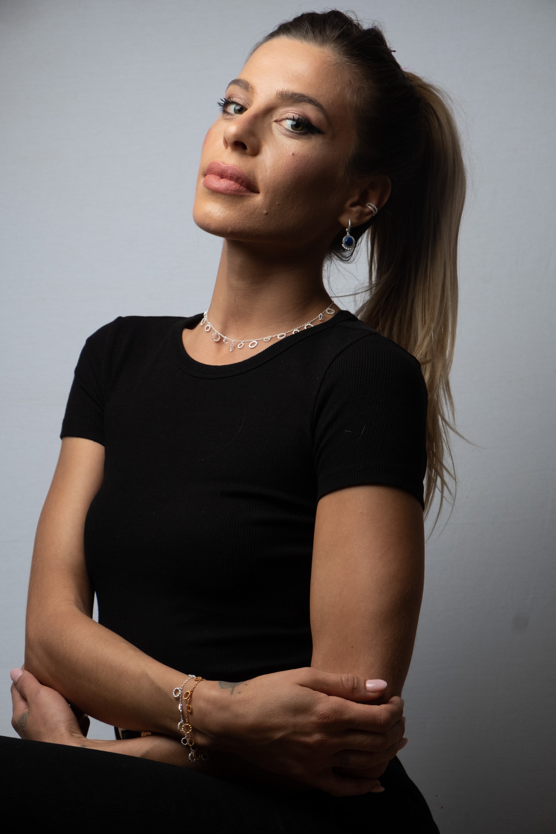 Model wearing silver adjustable necklace with hammered disc pendant