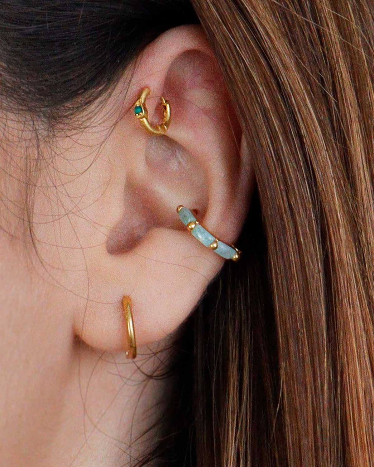 Close-up of gold mini hoop earrings with baguette-cut amazonite gemstones