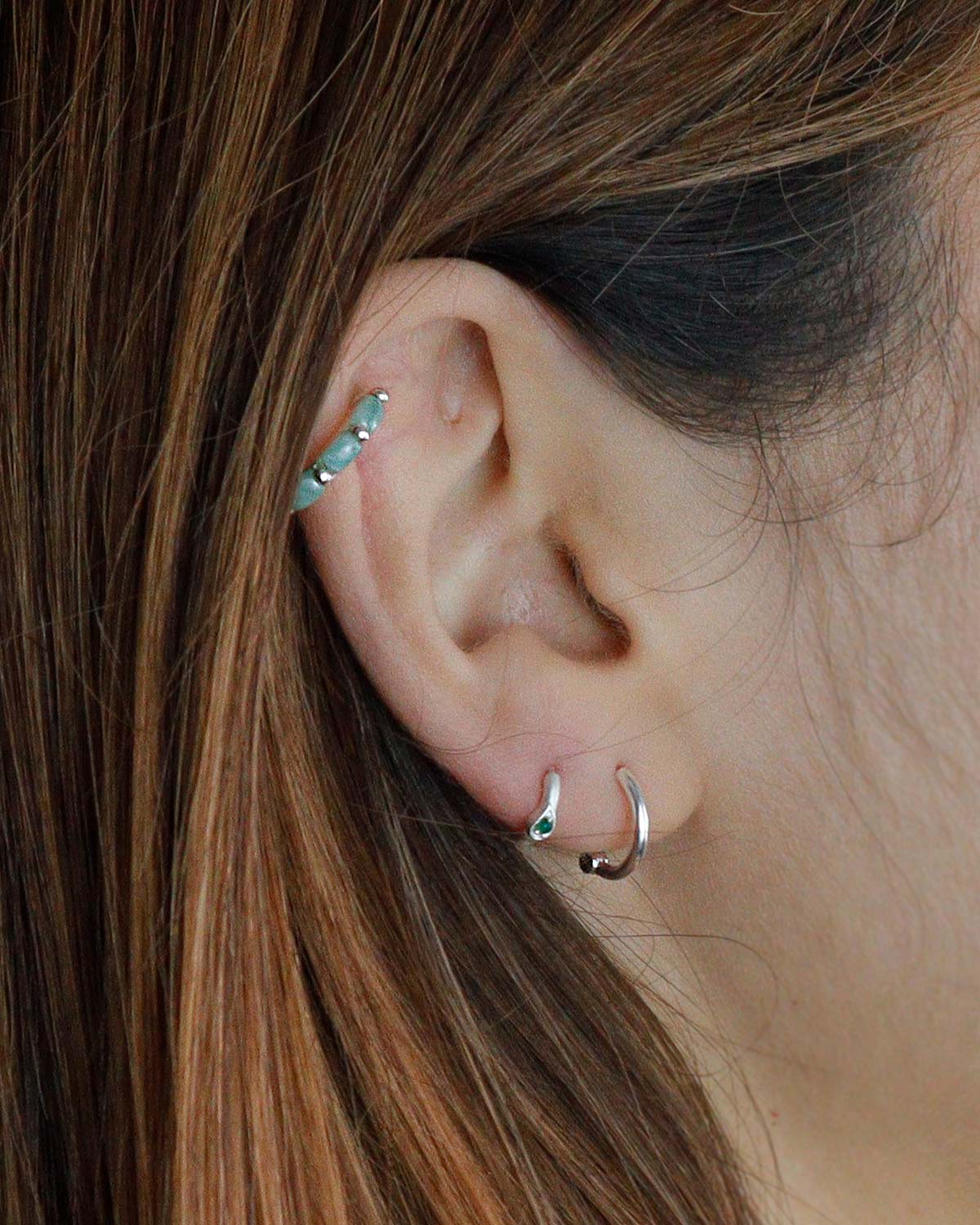 Model wearing silver mini hoop earrings with amazonite gemstones