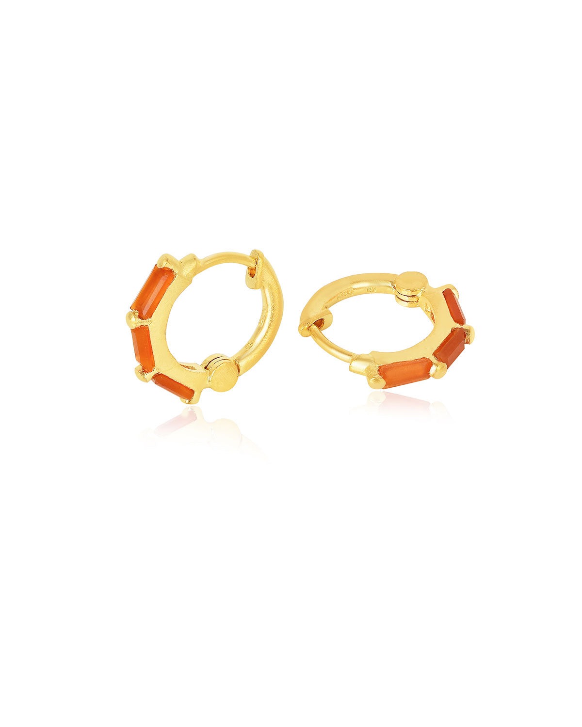 Gold mini hoop earrings with carnelian gemstones styled in a stacked look