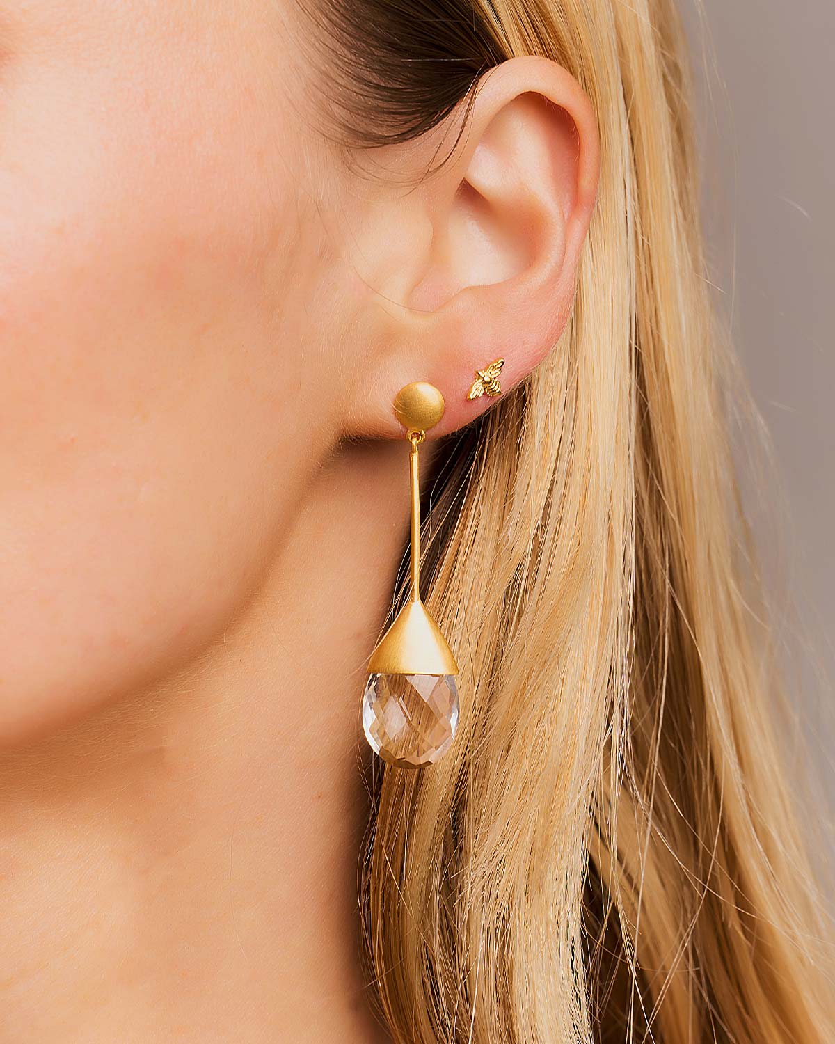 Side angle of drop earrings highlighting the dangling natural crystal gemstones