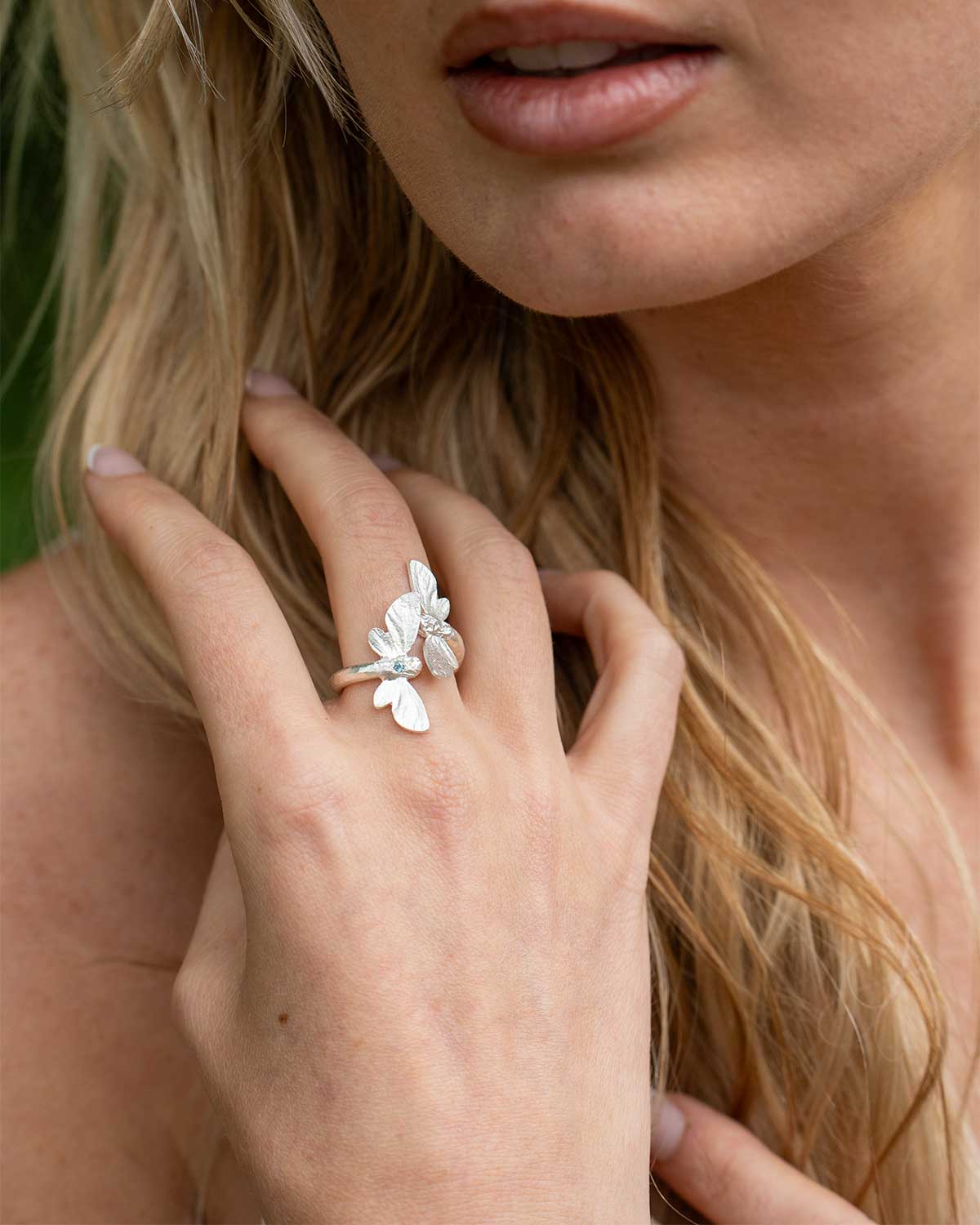 Close-up of silver ring featuring Swiss Blue Topaz and detailed butterfly design