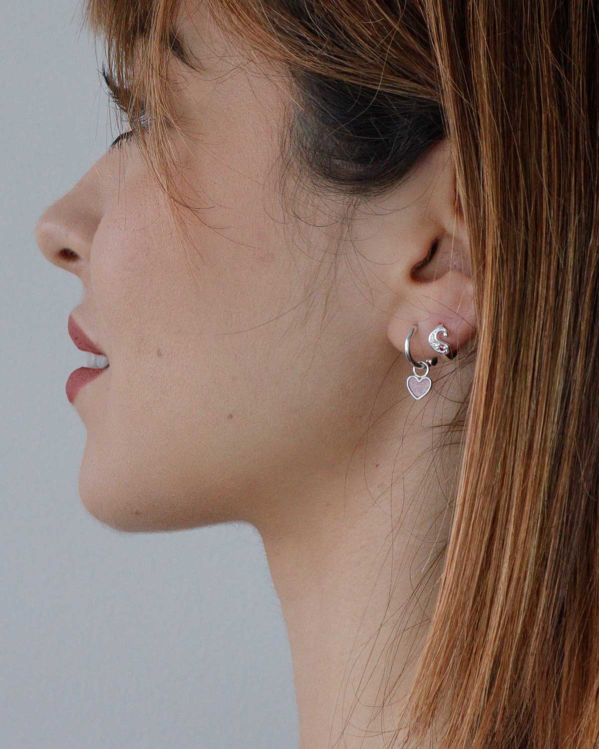 Single silver mini hoop earring with a reversible enamel heart charm