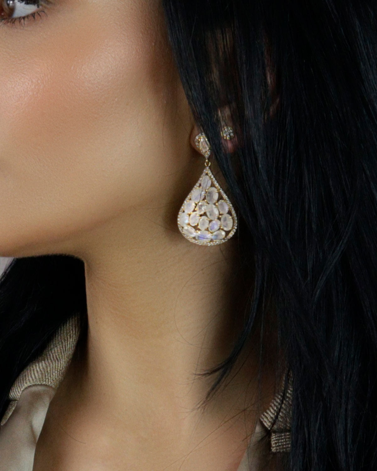 Side angle of gold earrings with labradorite stones and crystal details