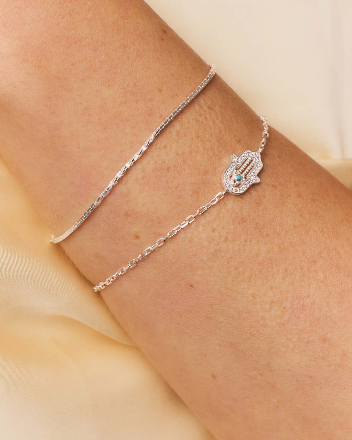 Close-up of sterling silver bracelet showing two chain patterns and polished finish
