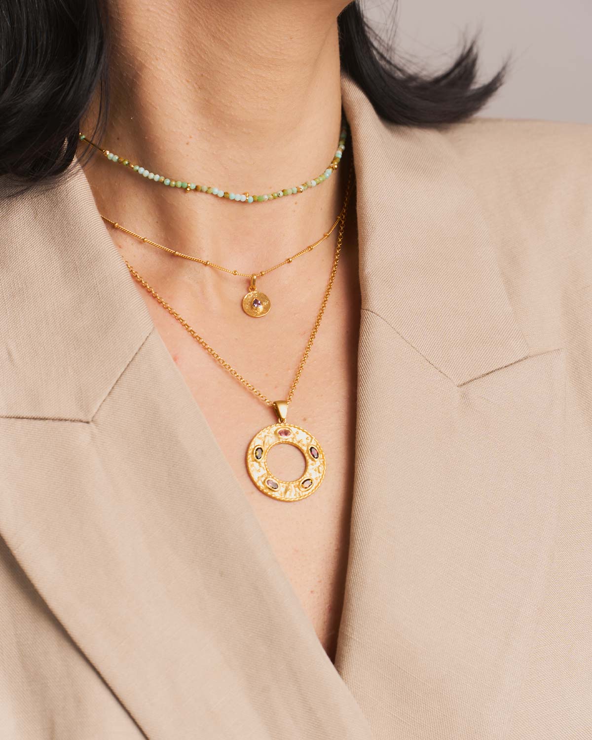 Close-up of a gold necklace with multicolour tourmaline gemstones