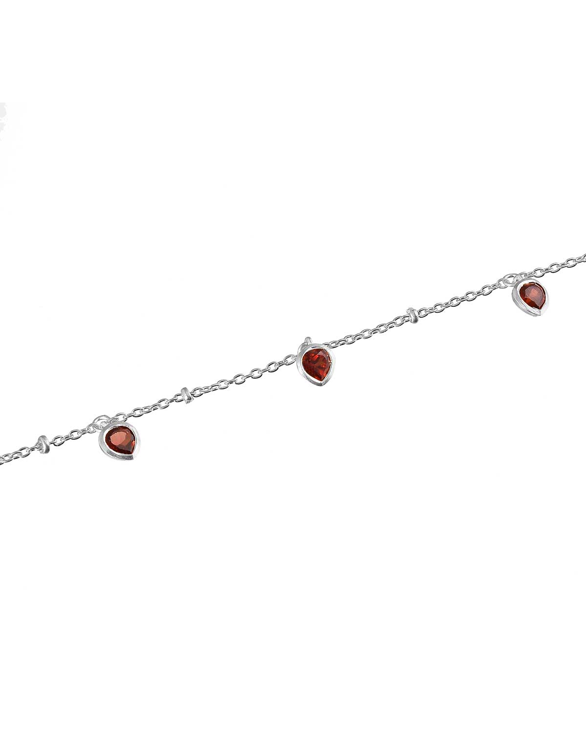 Close-up detail of sterling silver bracelet with a garnet heart charm