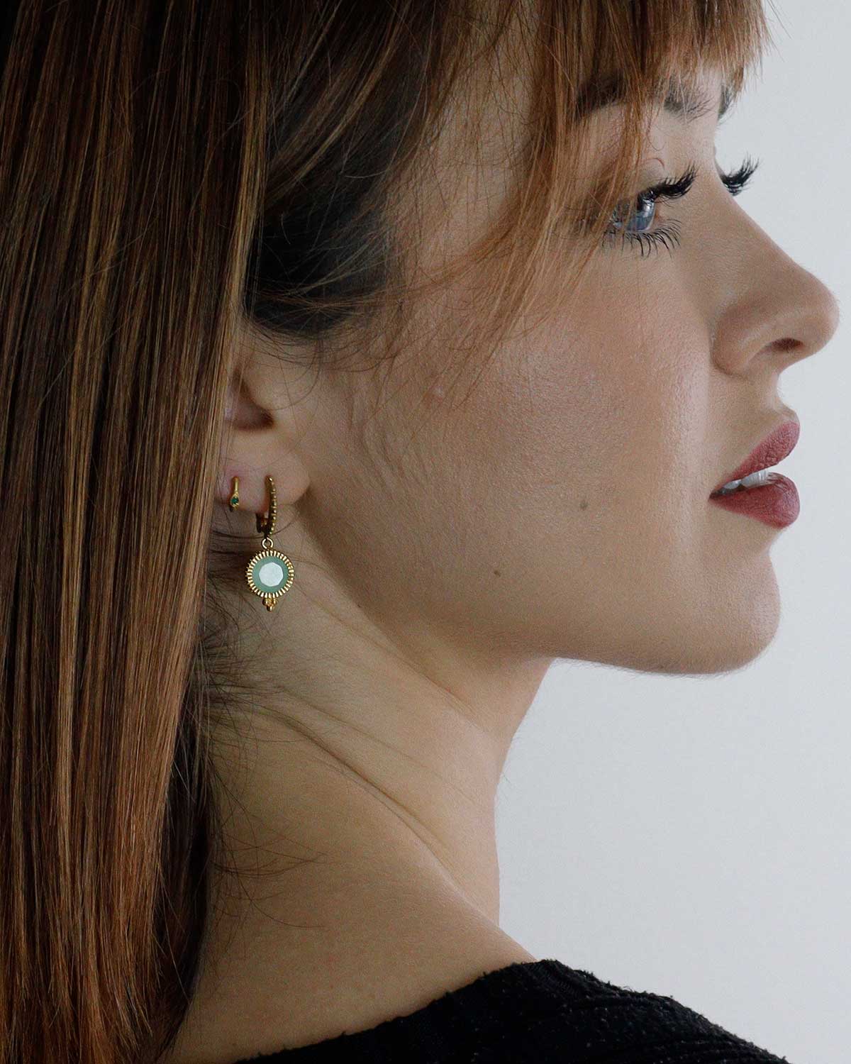 Side angle of gold mini hoops with aqua chalcedony drop design