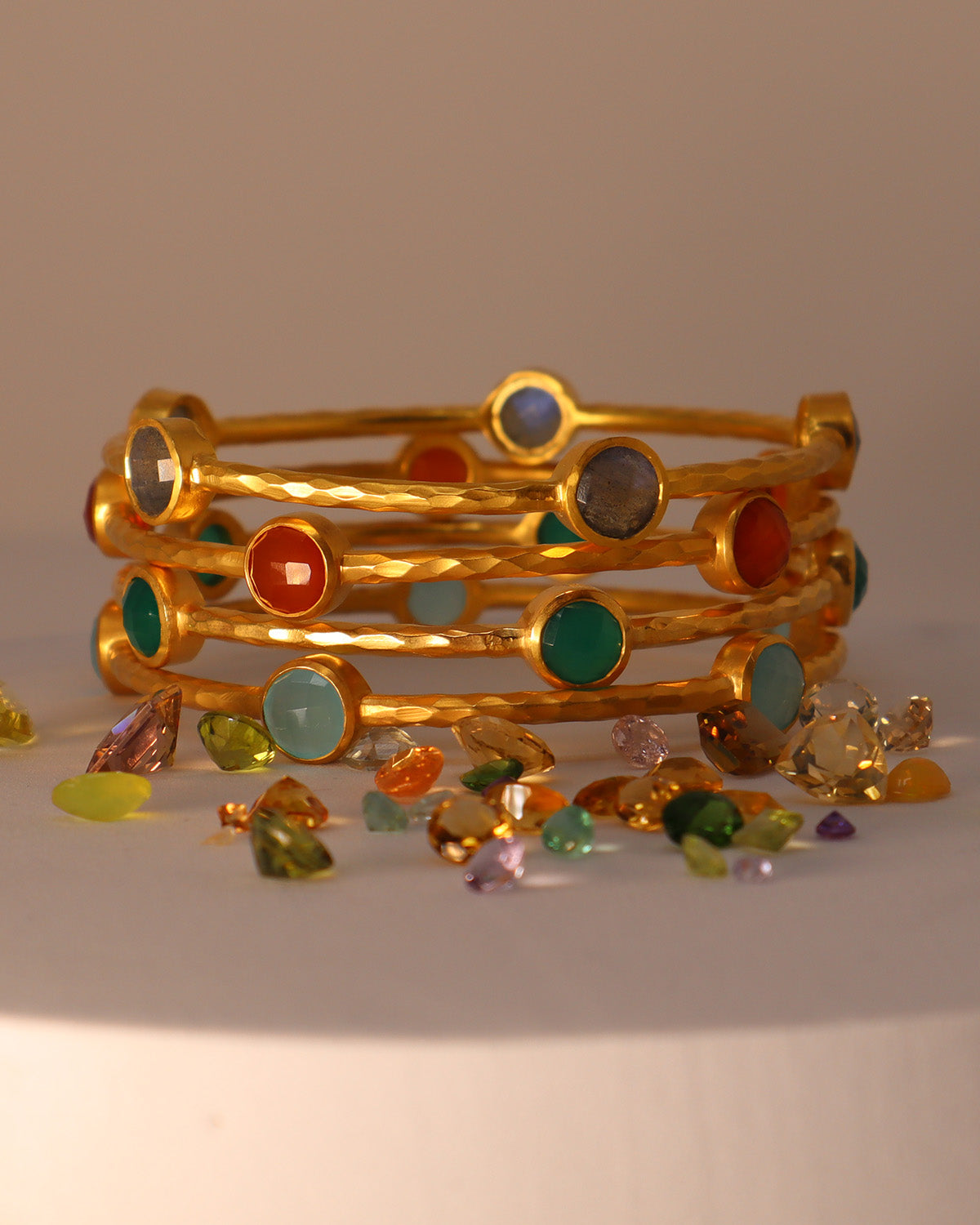 Close-up of the natural carnelian gemstone on a hammered gold bangle