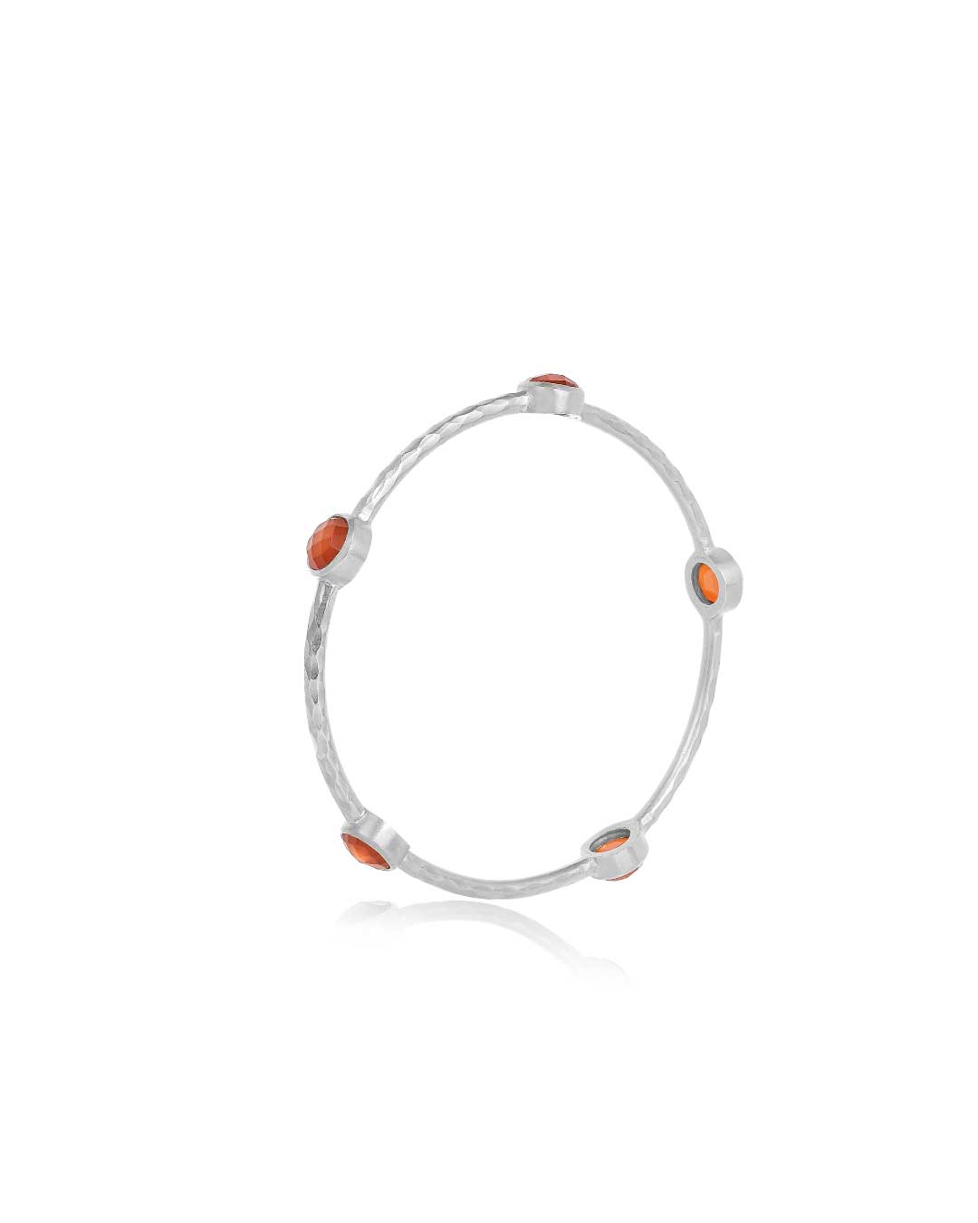Stacked silver bangles with carnelian gemstones and hammered texture