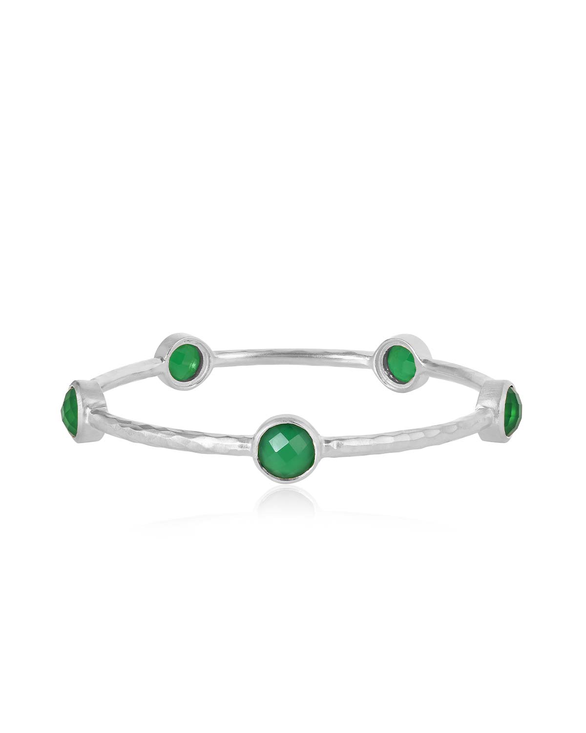 Bold silver bangles styled with smaller or plain bangles for a stacked look