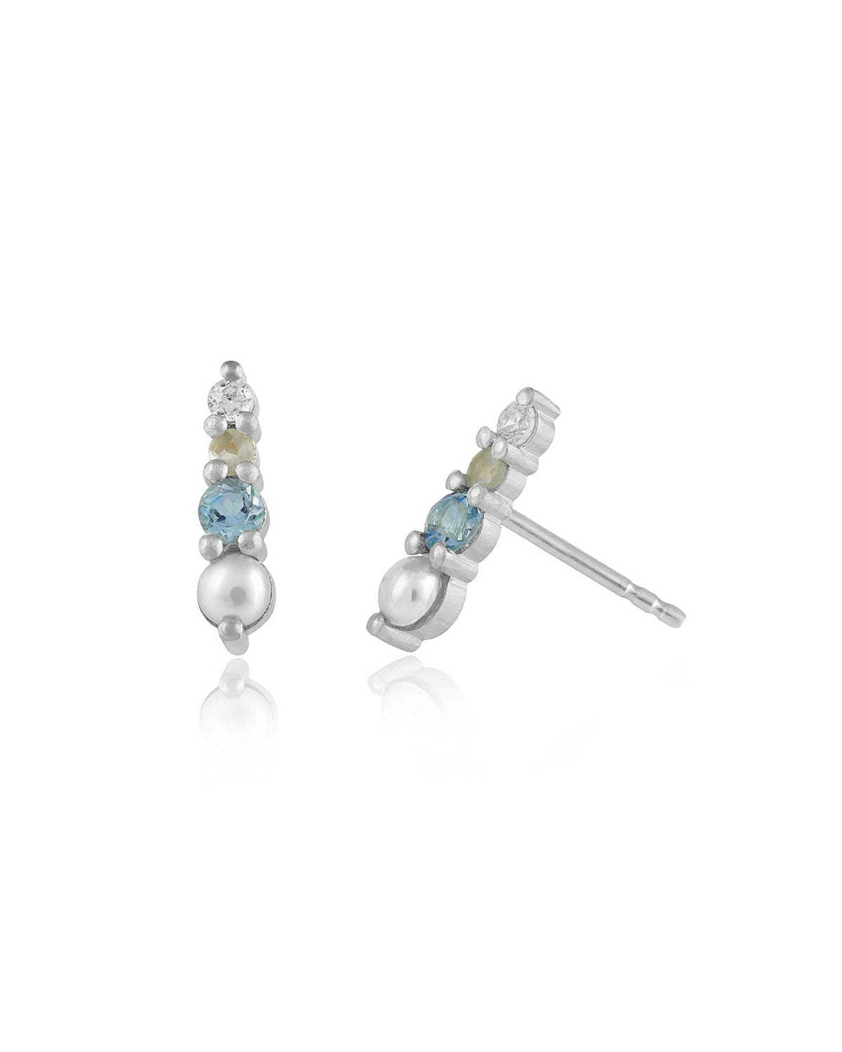 Close-up of mini silver stud with blue topaz, pearls, and cubic zirconia