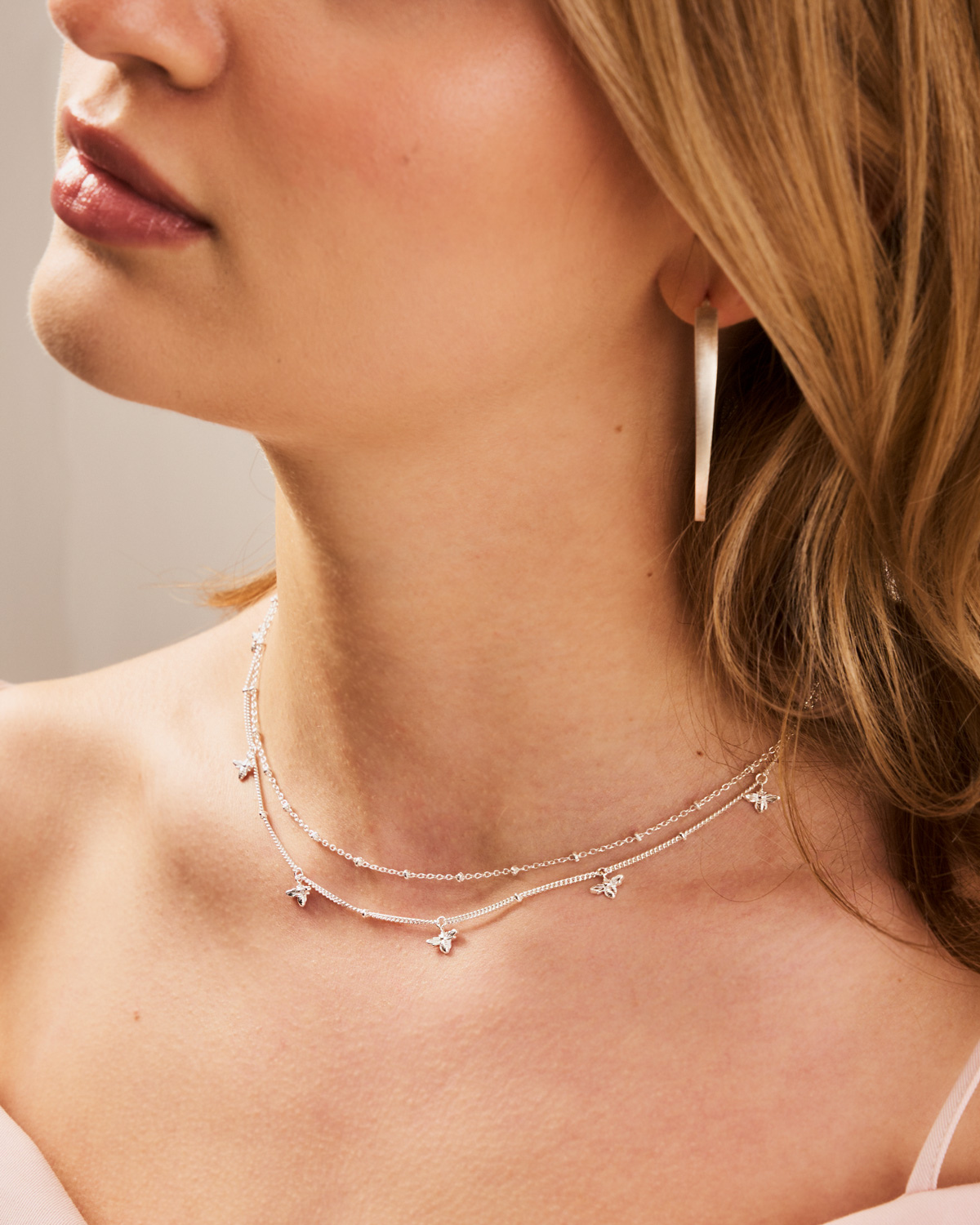 Close-up of sterling silver necklace with intricate handcrafted bee details