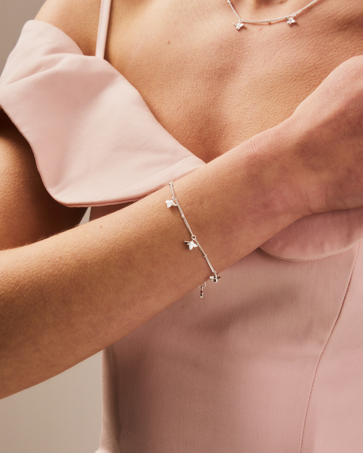 Close-up of silver adjustable bracelet featuring intricately handcrafted bees