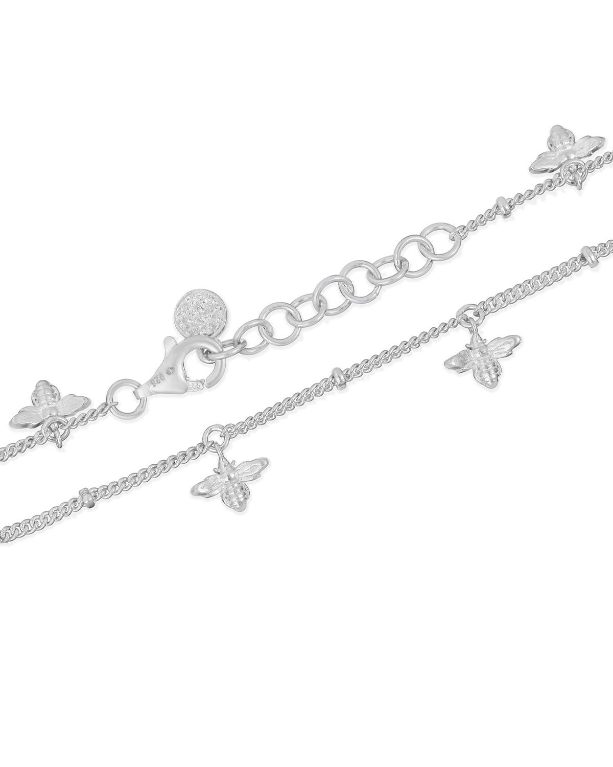 Detailed view of silver adjustable bracelet with delicate bee motifs